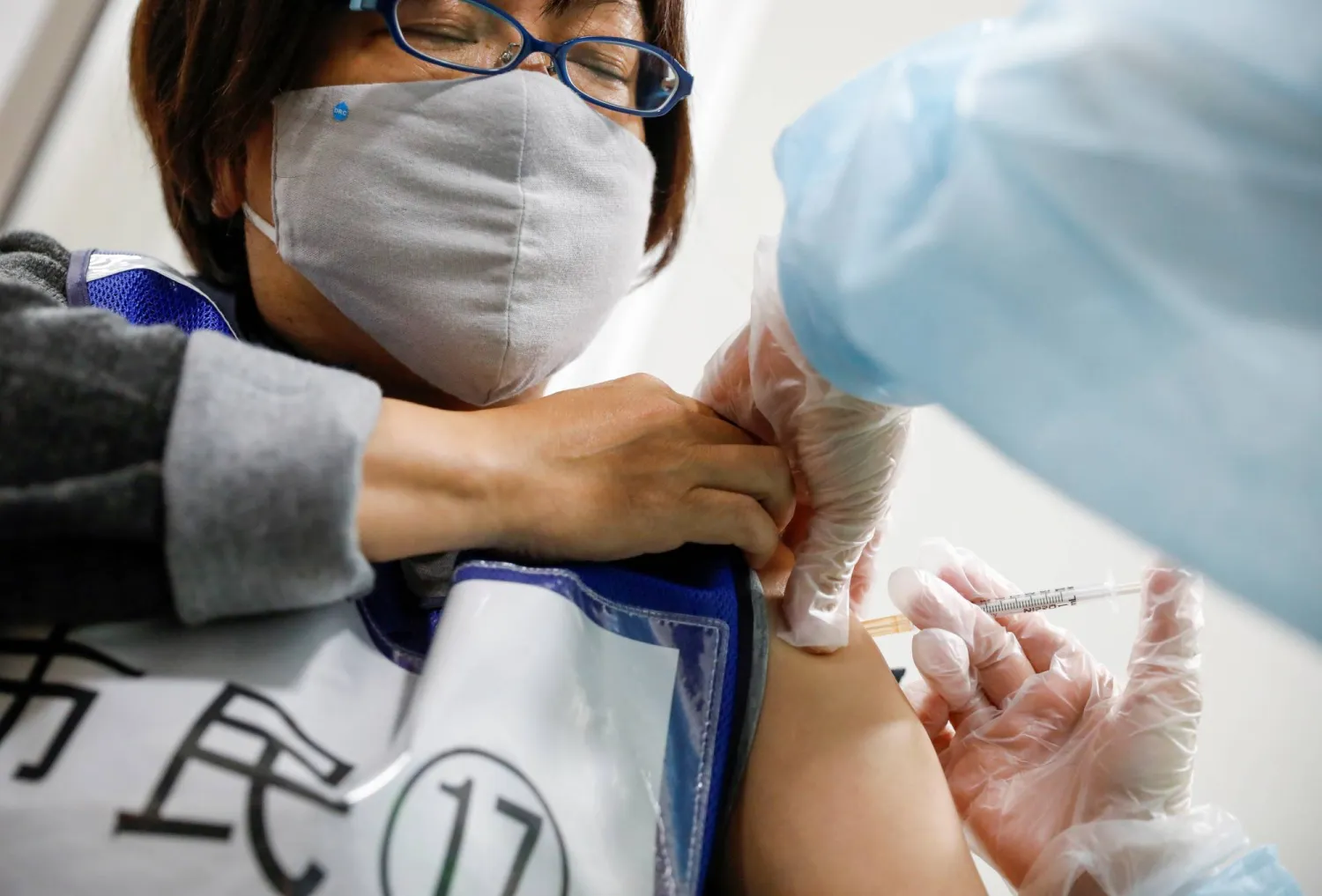 A participant receives a mock COVID-19 vaccine shot during an inoculation drill at a shopping mall in Japan. Reuters file photo
