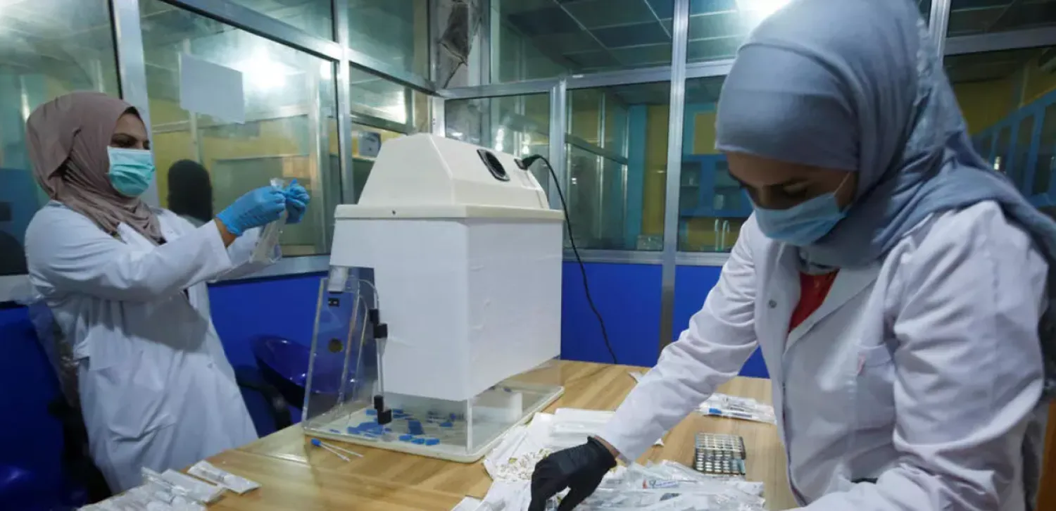 Iraqi doctors make testing components for the coronavirus disease (Covid-19) in Basra, Iraq March 29, 2020. Reuters