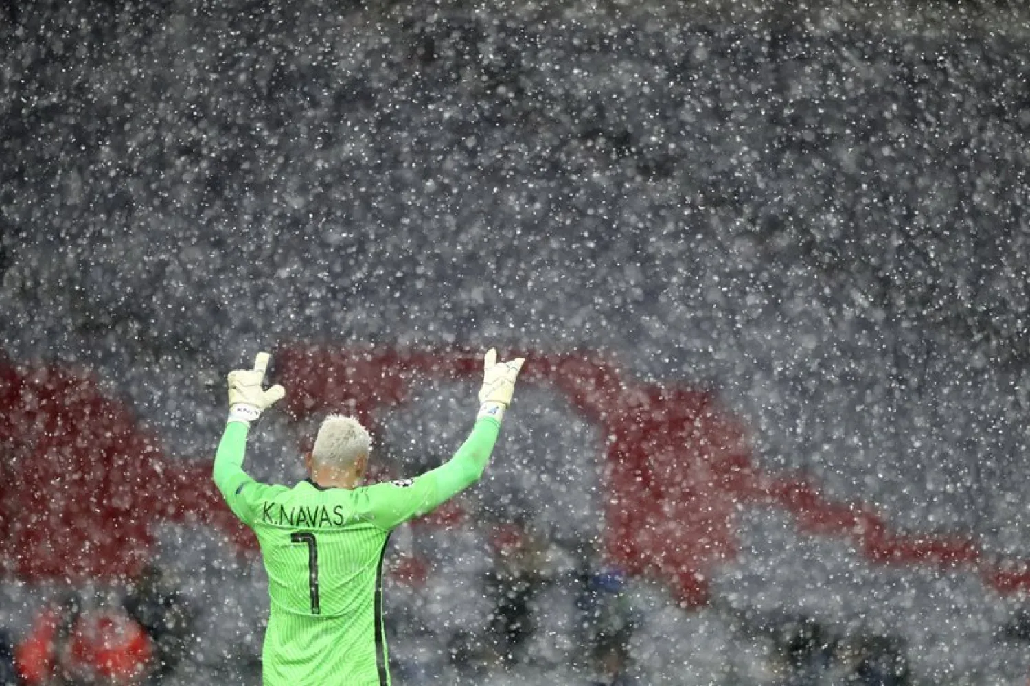 Snow falls as PSG's goalkeeper Keylor Navas reacts after the Champions League quarterfinal match between Bayern Munich and PSG in Munich, Germany, Wednesday, April 7, 2021. (AP)