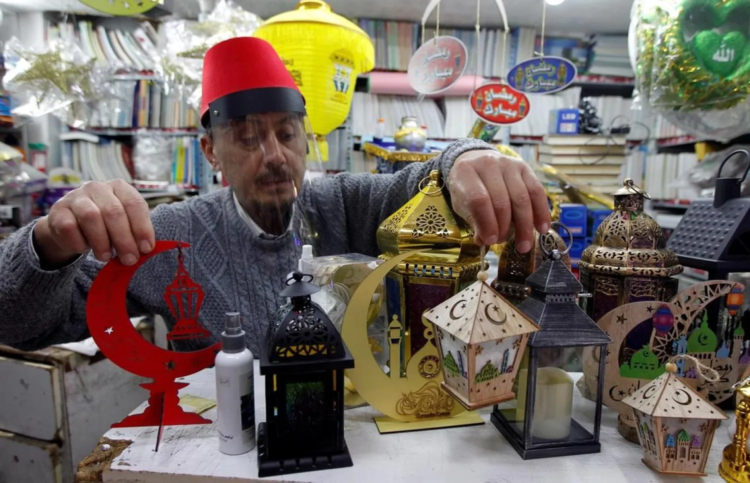 A man sells traditional Ramadan lanterns ahead of the Muslim holy month of Ramadan at a shop during a countrywide lockdown over the coronavirus disease (COVID-19) in Beirut, Lebanon. (Reuters)