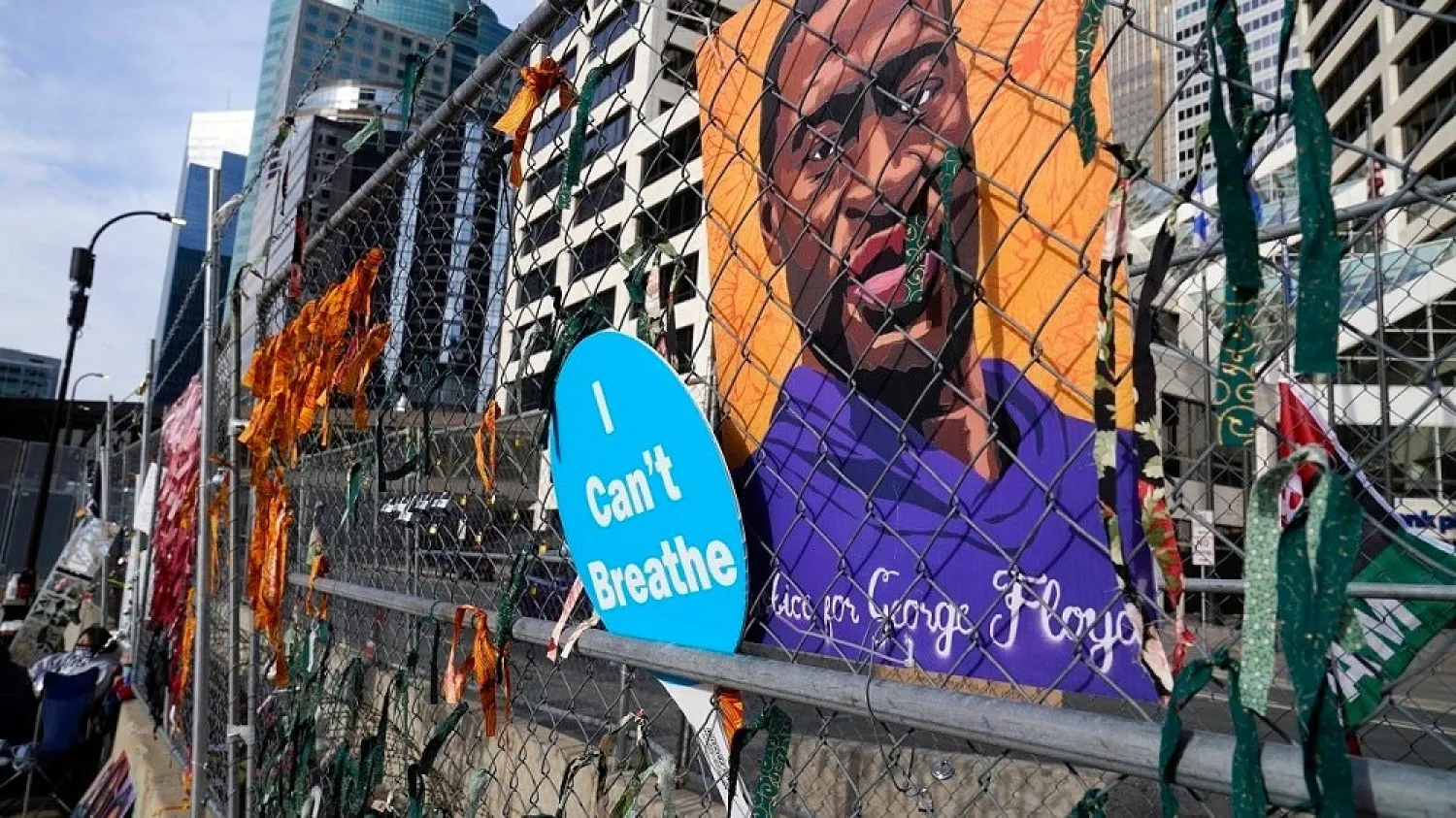 A picture of George Floyd hangs on a fence outside the Hennepin County Government Center, March 30, 2021, where the trial for former Minneapolis police officer Derek Chauvin continues. (AP)