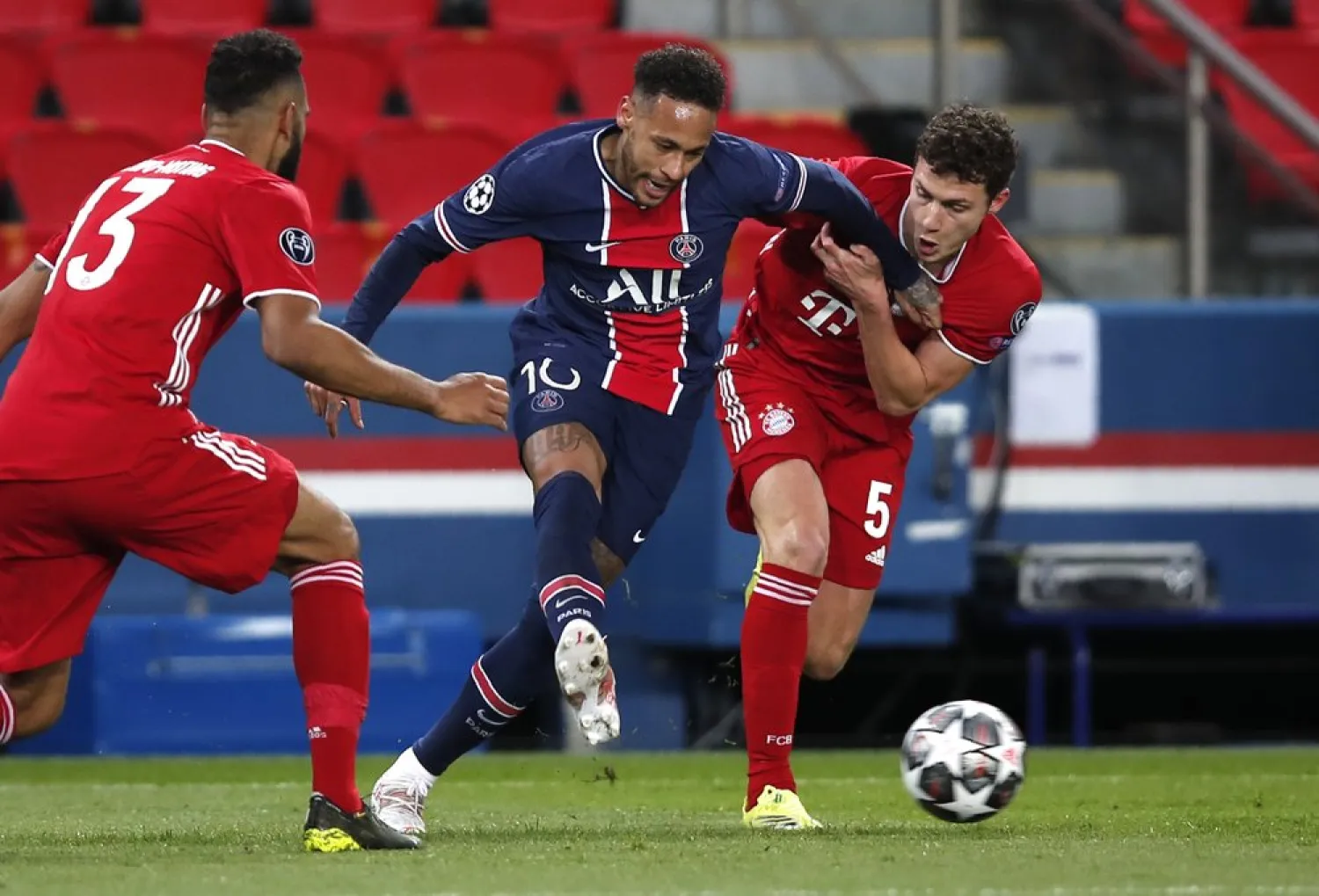 Bayern's Eric Maxim Choupo-Moting, left, Bayern's Benjamin Pavard, right, and PSG's Neymar challenge for the ball during the match at the Parc des Princes stadium, in Paris, France, April 13, 2021. (AP) 