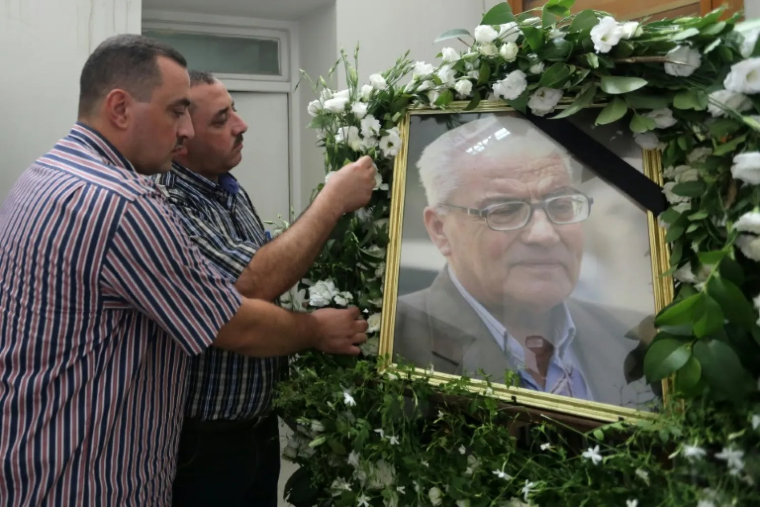 The sons of Khaled al-Assaad, former chief archaeologist of Palmyra who was beheaded by the ISIS when he refused to leave the ancient city when it fell to the militants- AFP