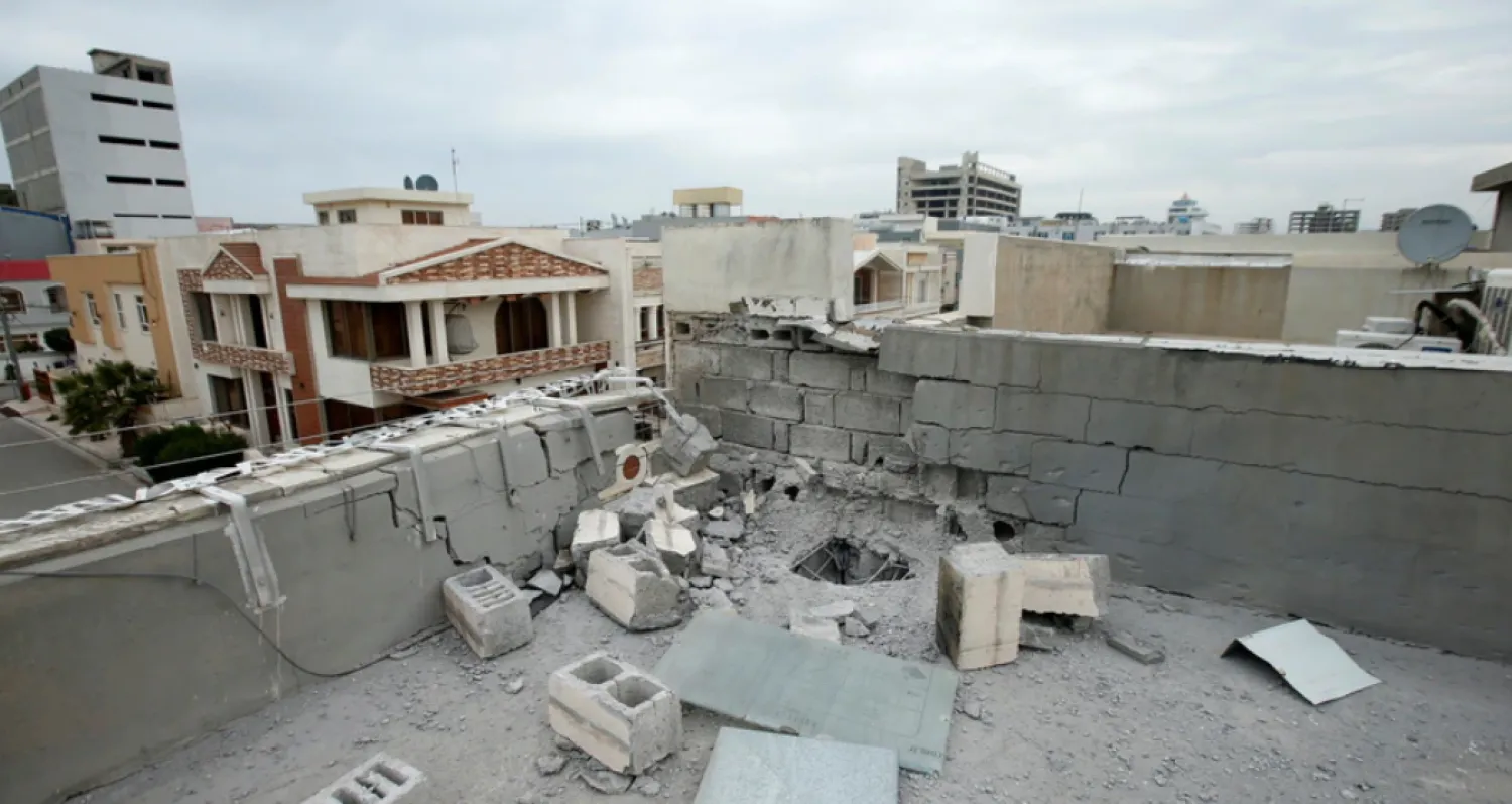 FILE - A damaged roof is seen after a barrage of rockets hit in and near Erbil International Airport, in Erbil, Feb. 16, 2021. Reuters