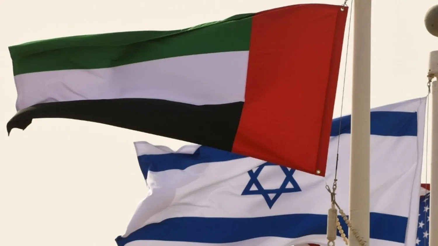 The Emirati, Israeli and US flags sway in the wind at the Abu Dhabi airport at the arrival of the first-ever commercial flight from Israel to the UAE, on August 31, 2020. (AFP)
