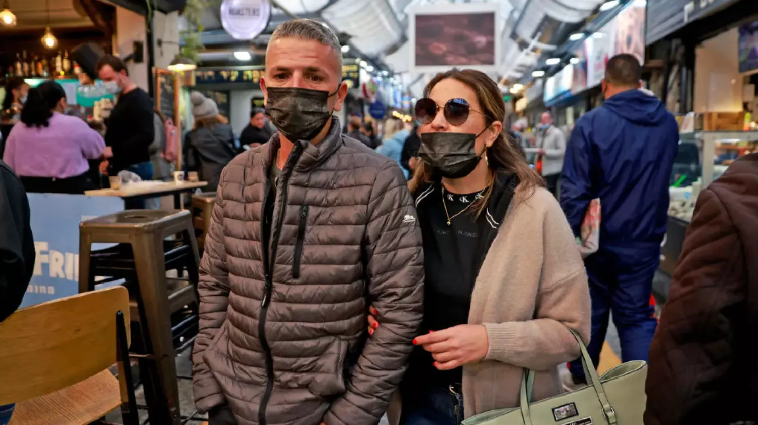 Israelis walk in Jerusalem's Mahane Yehuda market, on March 18, 2021 wearing the mandatory face mask as part of efforts by authorities to stem coronavirus - AFP