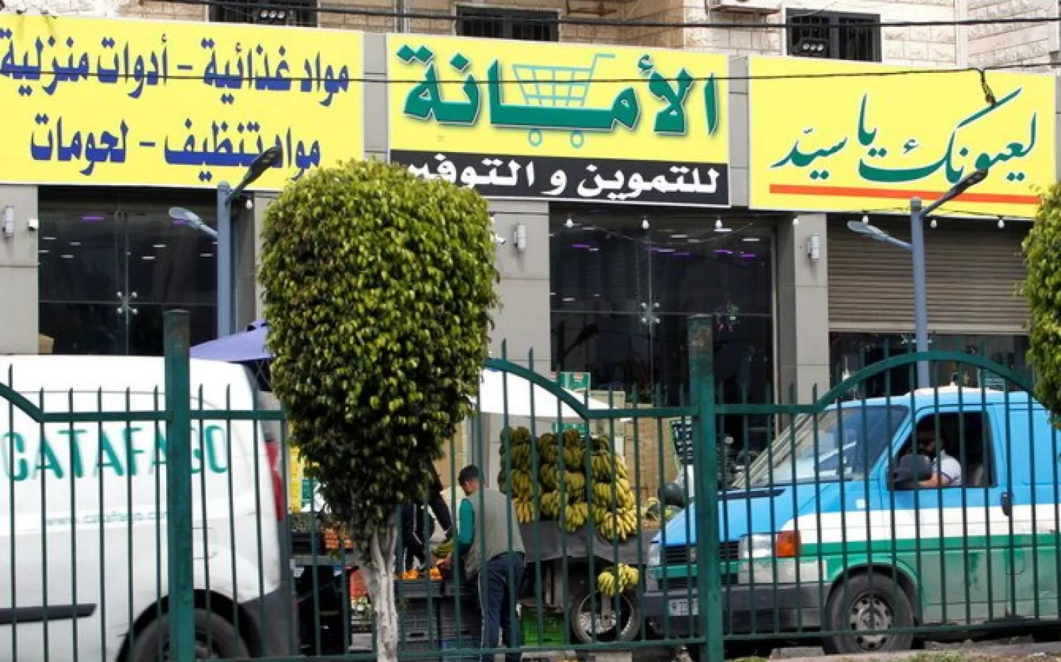 A view shows a market for groceries with a Hezbollah slogan on it, in Beirut suburbs. (REUTERS)

