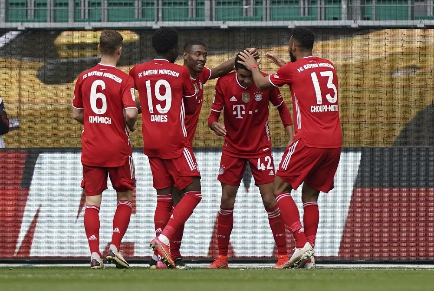 Bayern's Jamal Musiala, second right, celebrates after scoring his side's third goal during against VfL Wolfsburg in Wolfsburg, Germany, Saturday, April 17, 2021. (AP)