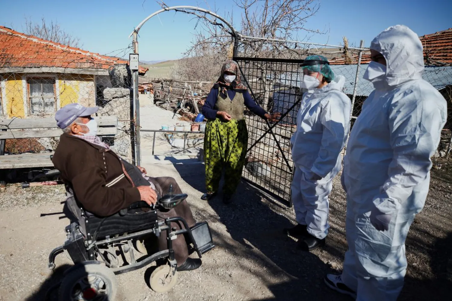 Health workers chat with Hakki Karakaya and his wife Ferdane Karakaya, an elderly couple living in Deliler village near Elmadag, after administering the Sinovac's CoronaVac COVID-19 vaccine at their home as nationwide vaccination continues for seniors, in Ankara, Turkey March 3, 2021. (Reuters)