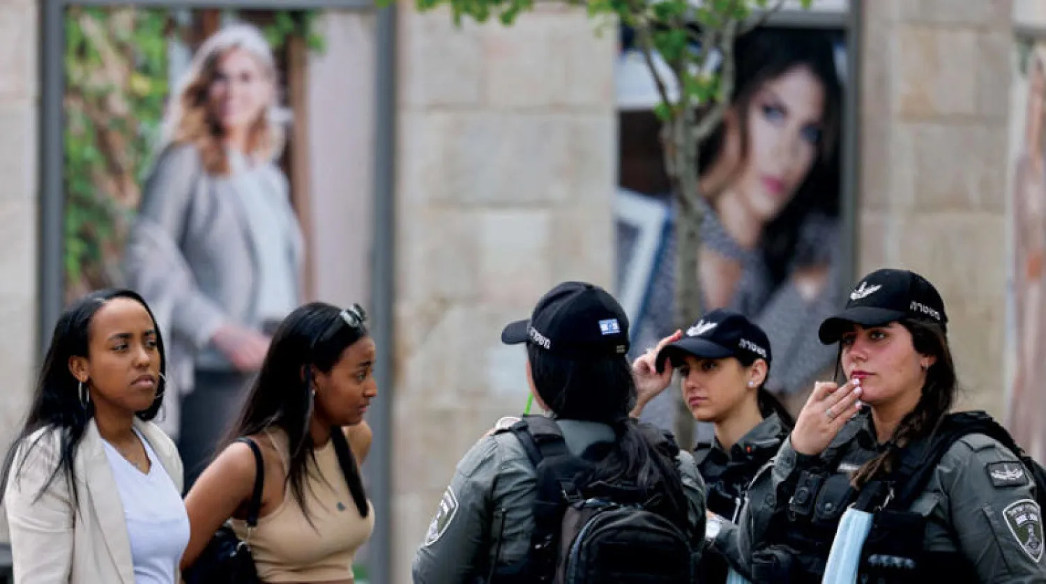 إسرائيليون بالقدس الغربية أمس بعد إلغاء ارتداء الكمامات في الأماكن العامة (أ.ف.ب)