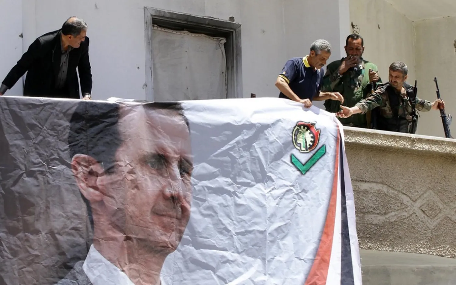 A banner displays the image of Syrian President Bashar al-Assad. (AFP file photo)