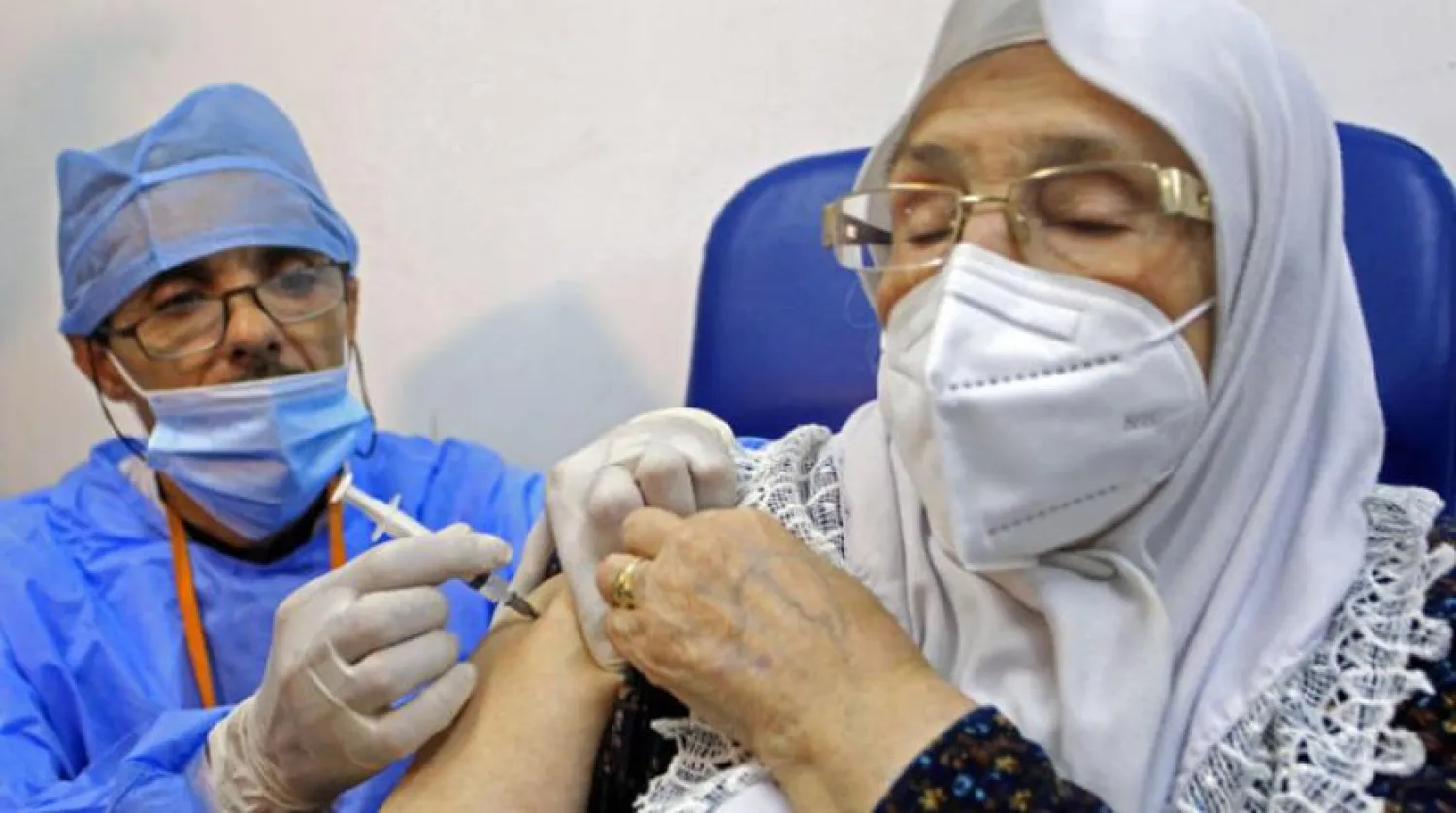 A woman receives a COVID-19 vaccine in Algeria in January. (AP)