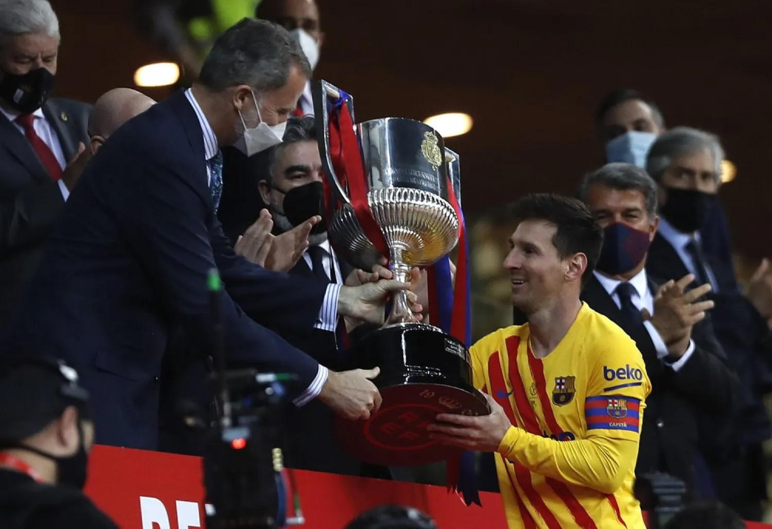 Barcelona's Lionel Messi receives the trophy by Spain's King Felipe after winning the Spanish Copa del Rey final 2021 against Athletic Bilbao at La Cartuja stadium in Seville, Spain, April 17, 2021. (AP)