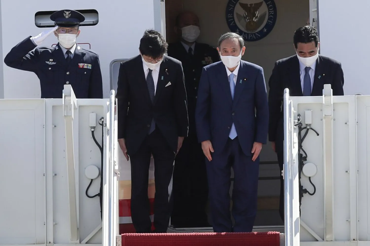 Japanese Prime Minister Yoshihide Suga boards his plane to depart at Andrews Air Force Base, Md., Saturday, April 17, 2021, after his visit to Washington. (AP)