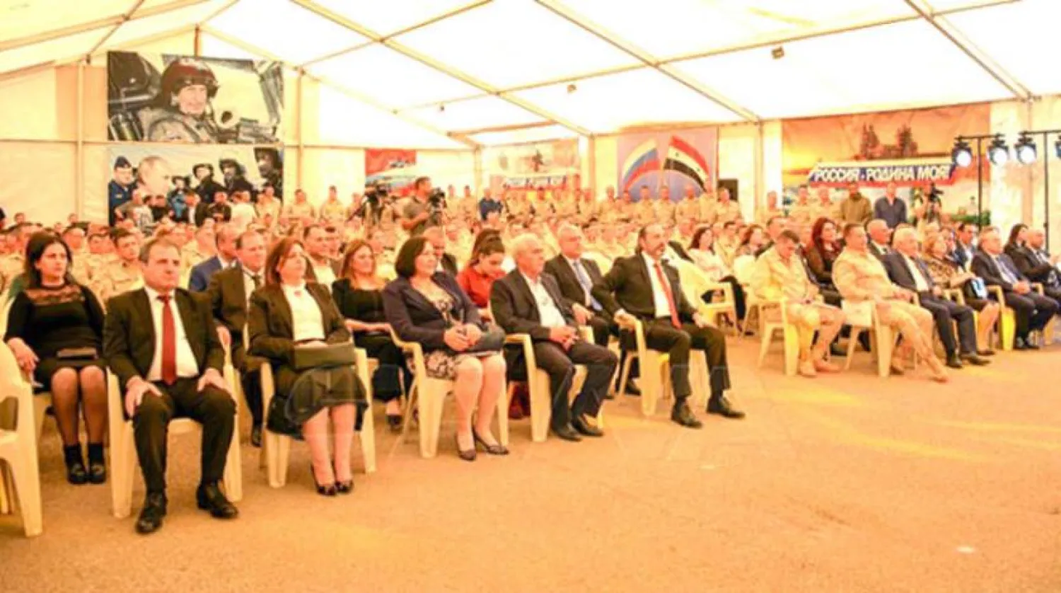 Officials at the event at the Hmeimim base. (SANA)