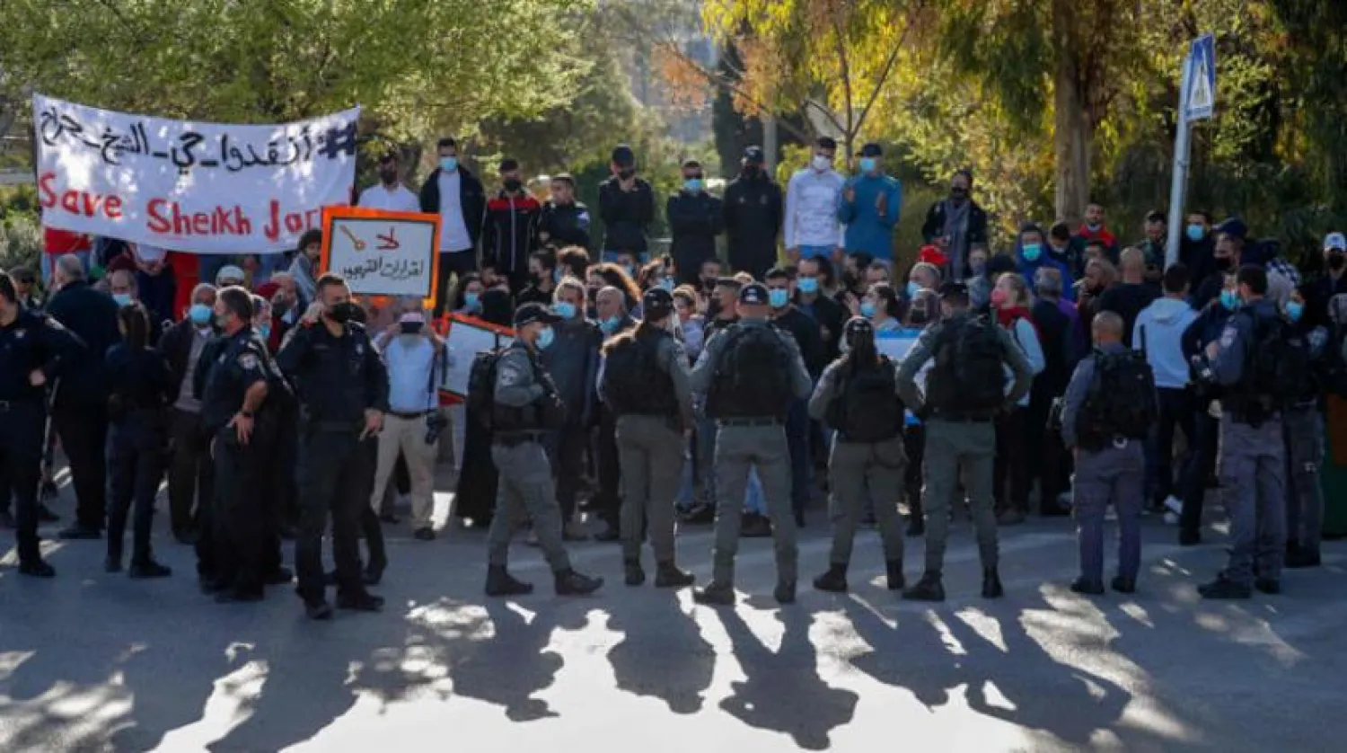 Israeli security forces surround activists protesting settlements in Sheikh Jarrah in Jerusalem. (AFP)