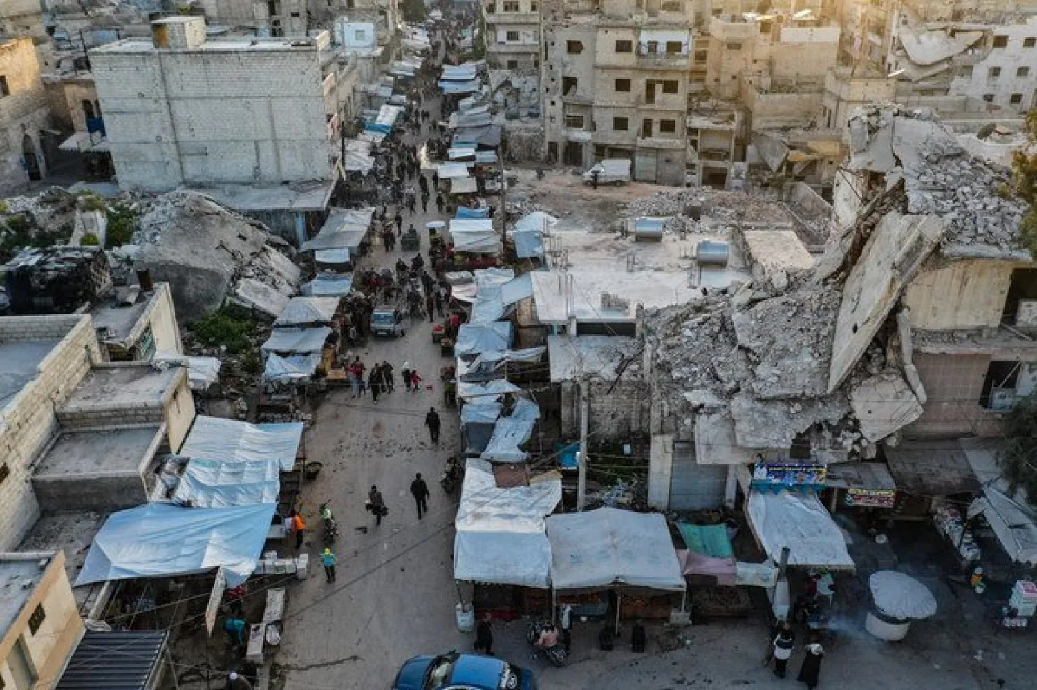 Syrians buying produce at a market ahead of iftar, the evening meal that ends the daily fast at sunset, in the war-ravaged city of Ariha in the Idlib province on the second day of Ramadan, April 15, 2021. (File/AFP)
