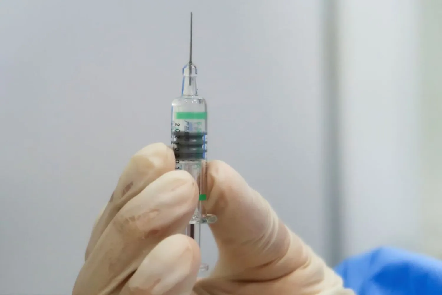 A nurse holds a syringe containing a coronavirus disease (COVID-19) vaccine made by the Beijing Institute of Biological Products at a vaccination center during a government-organized visit, in Beijing, China, April 15, 2021. REUTERS/Thomas Peter