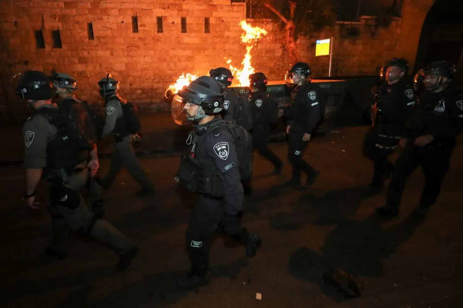 Israeli police officers walk during clashes with Palestinian protesters, as the Muslim holy fasting month of Ramadan continues, in Jerusalem, April 24, 2021. (Reuters)