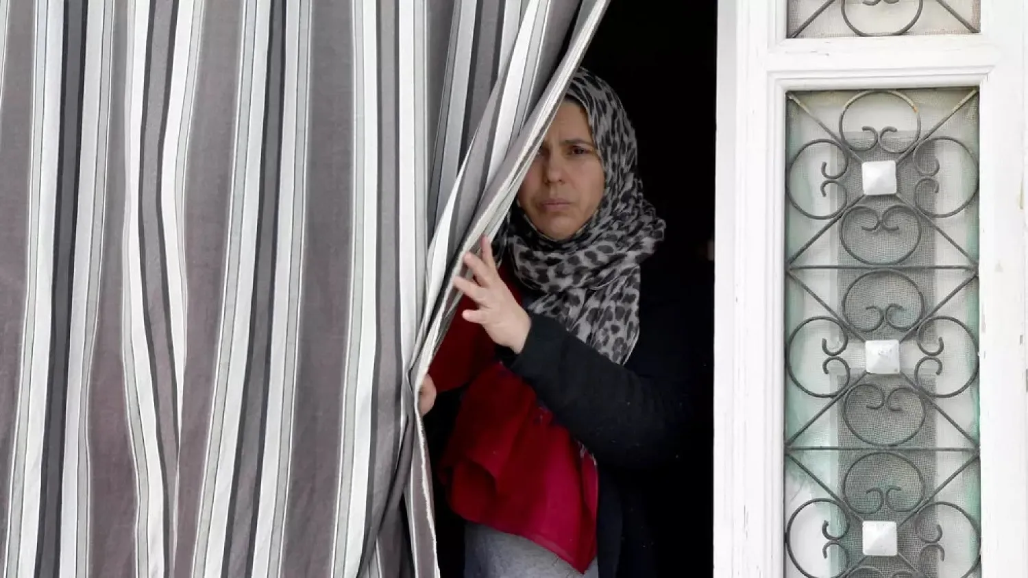 The sister of Jamel Gorchene declines to speak with reporters at the family home in Tunisia while other relatives voiced shock and disbelief. (AFP)