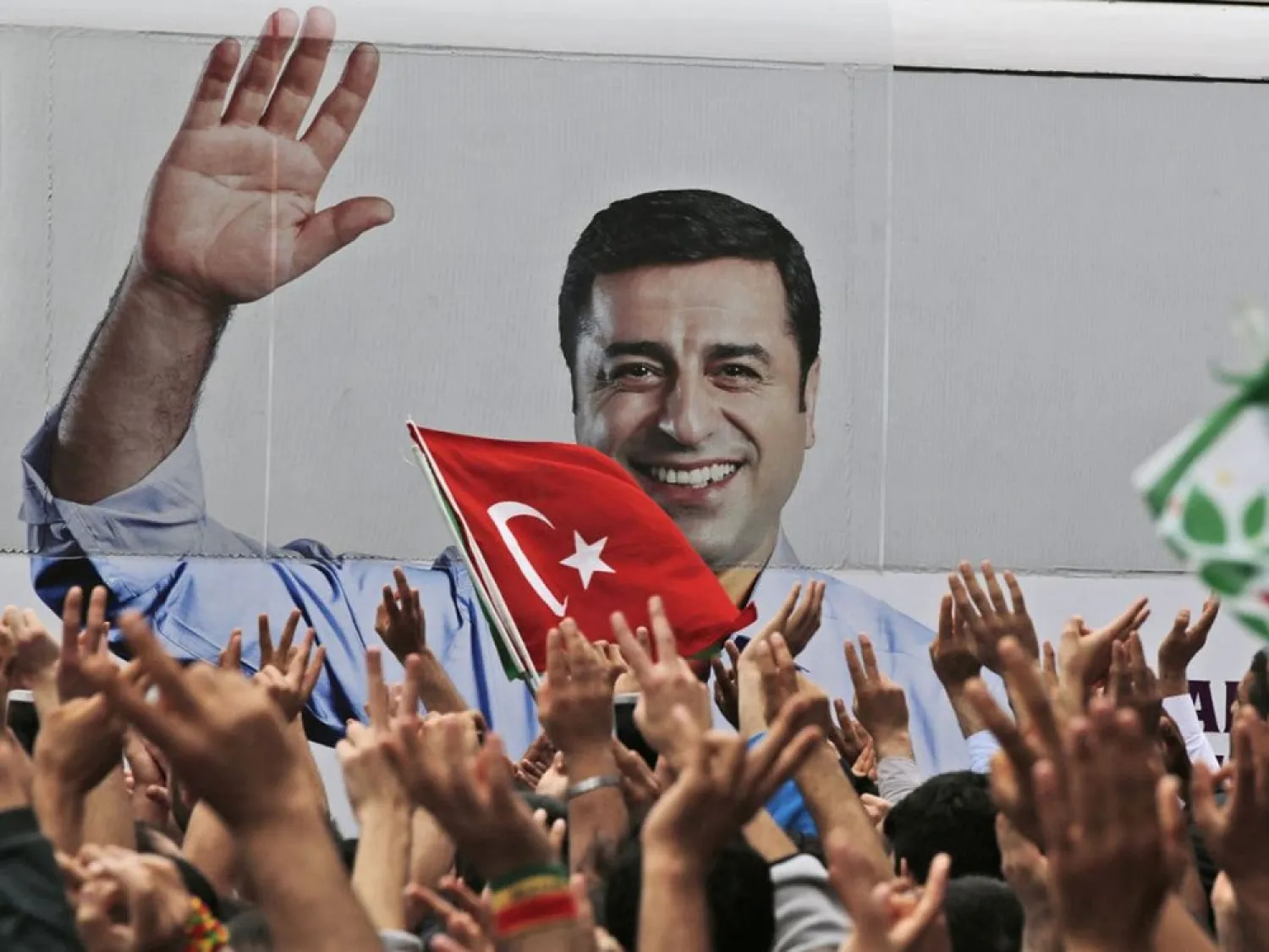 A bus carrying Selahattin Demirtas, his image on its side, drives off after a rally in Istanbul. (AP file photo)