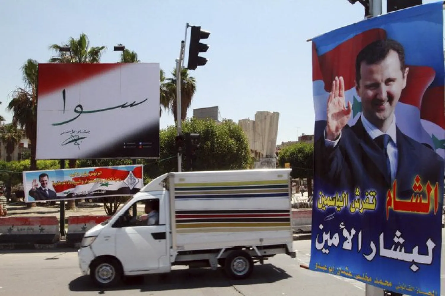 Campaign poster for May 2014 presidential elections in Damascus. On Monday, Paris-based Syrian Network for Human Rights called on the international community to reject presidential elections scheduled for next month May. (AP)
