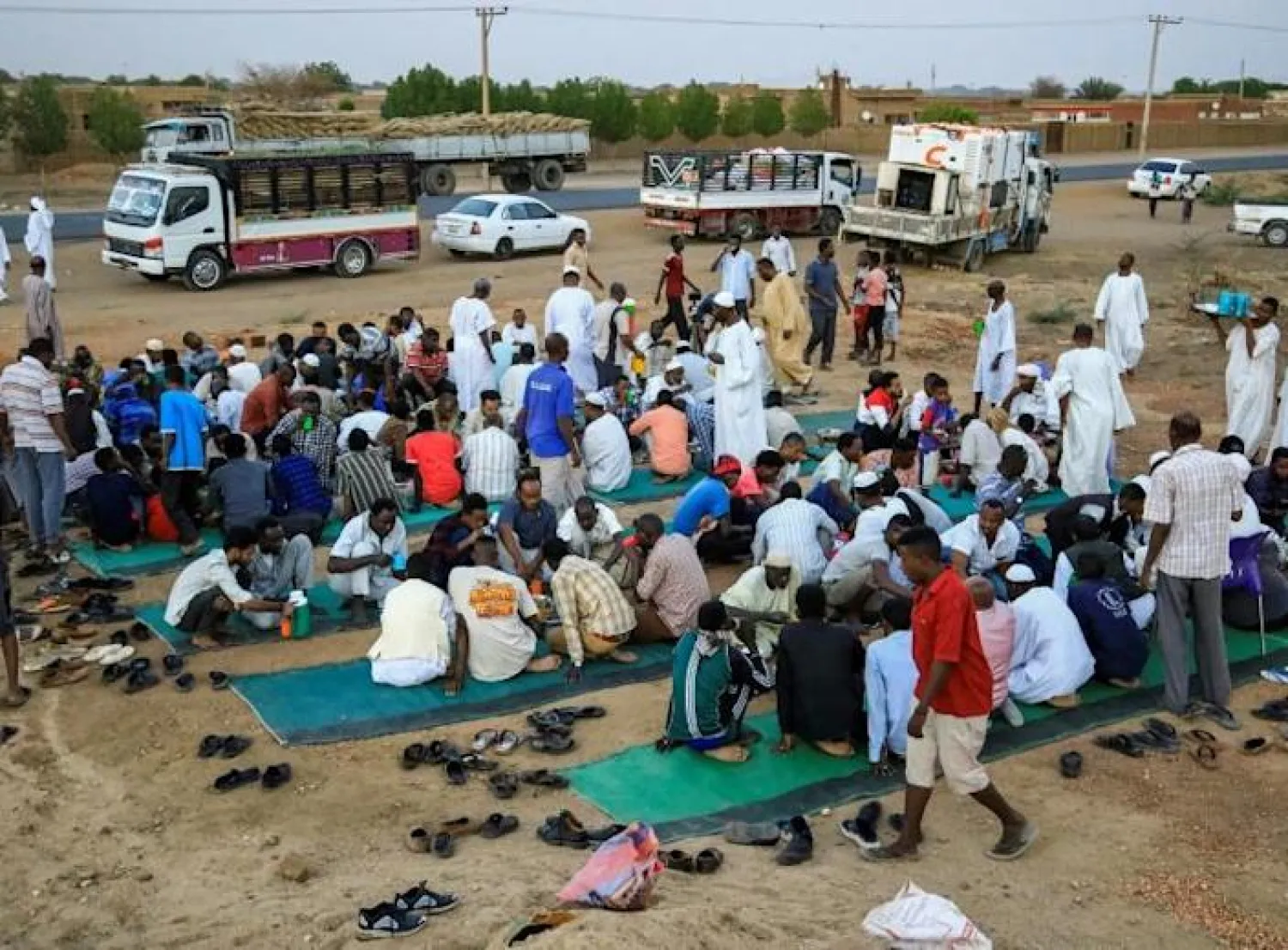 Sudanese break their Ramadan fast on the side of the road in the village of Nuba, where locals share their food with strangers - AFP


