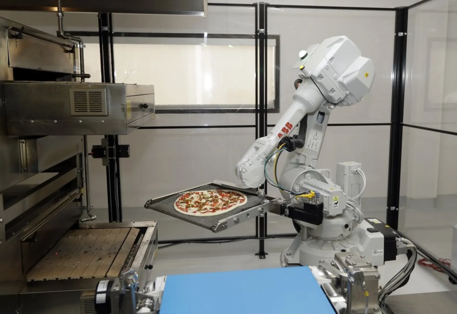 In this Aug. 29, 2016, file photo, a robot places a pizza into an oven at Zume Pizza in Mountain View, Calif. (AP)