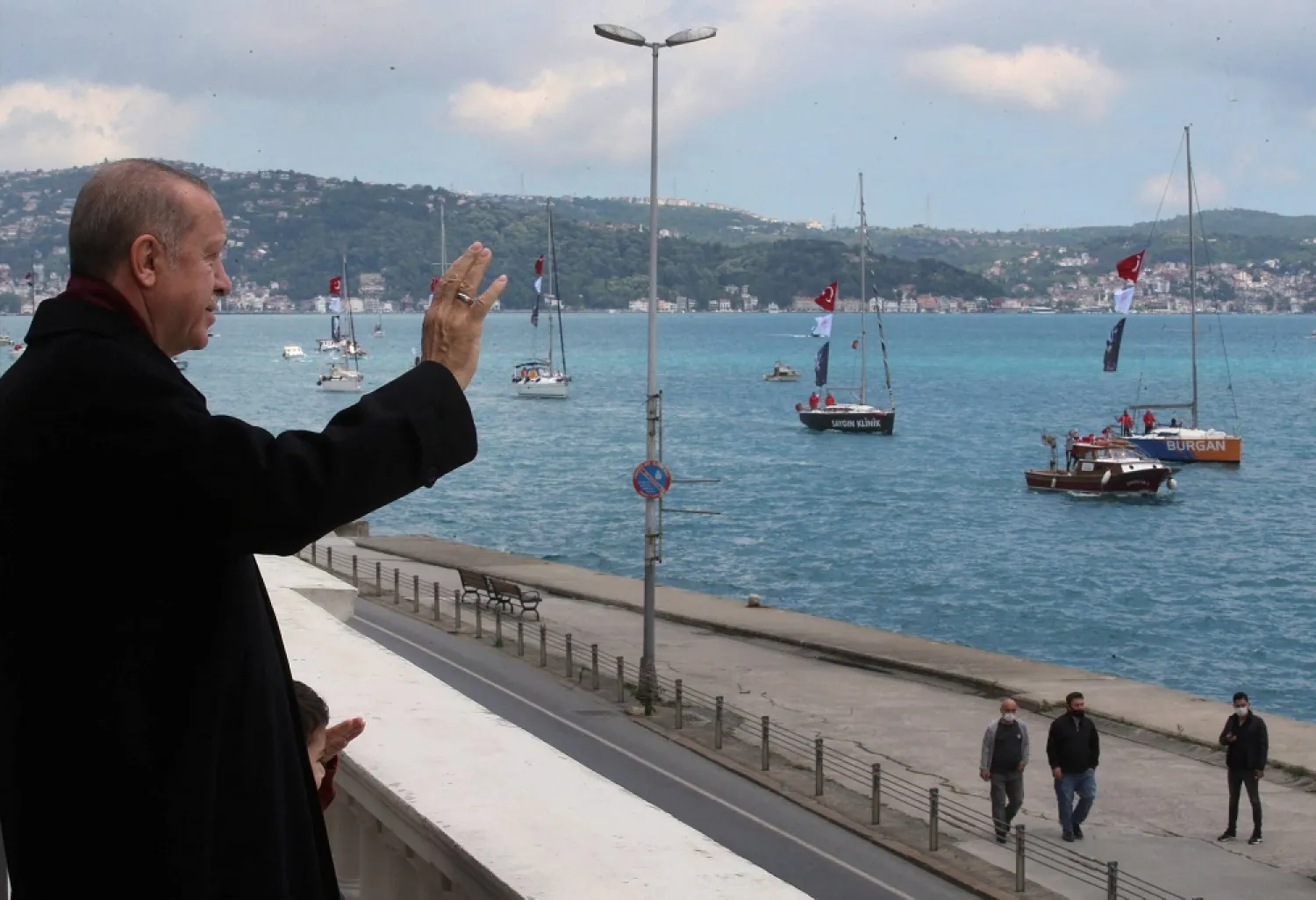 Turkey's President Recep Tayyip Erdogan salutes vessels as they sail the Bosphorus Strait in Istanbul last year. (AP)