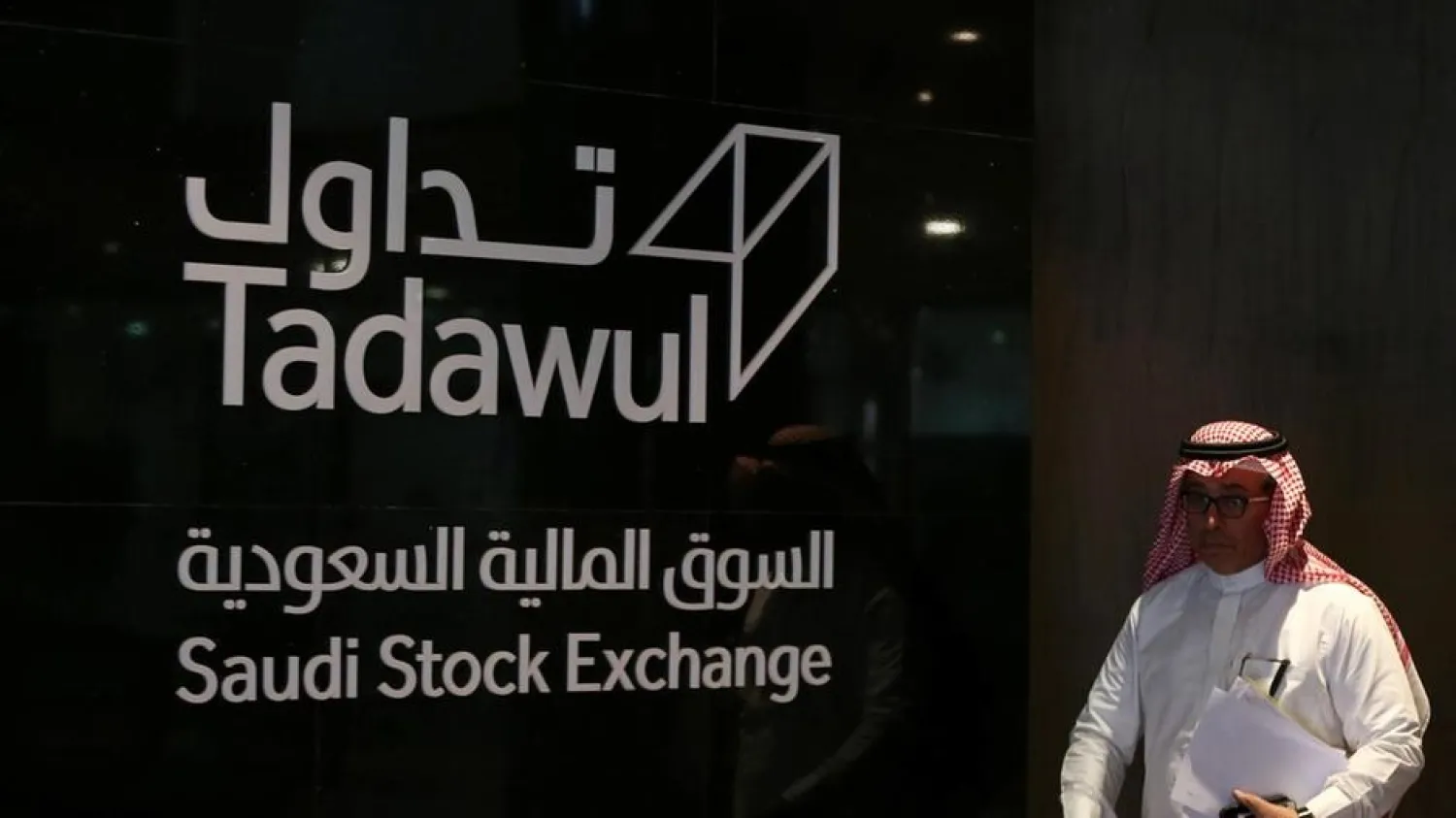 A Saudi man heads to the stock market with the start of Aramco's IPO, in Riyadh, Saudi Arabia. (Reuters)