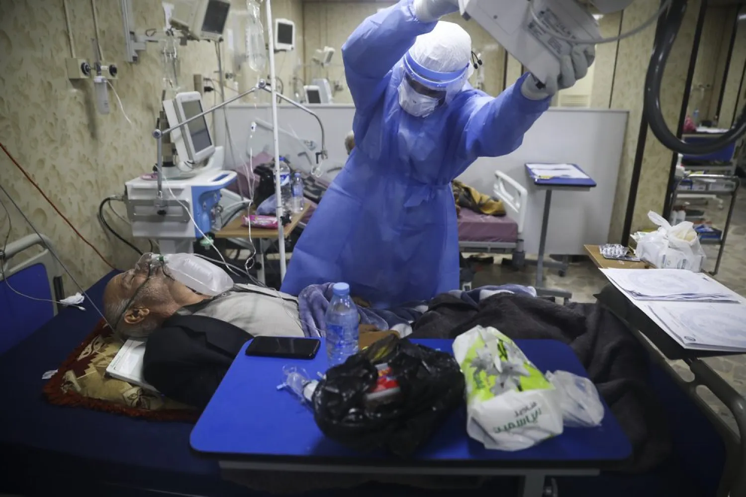 A medic works with corona patientsin a hospital in Idlib, Syria, Saturday, Nov. 14, 2020. At one of two coronavirus hospitals in Syria's Idlib province, overwhelmed medical staff tend to patients drifting in and out of consciousness.(AP Photo/Ghaith Alsayed)
