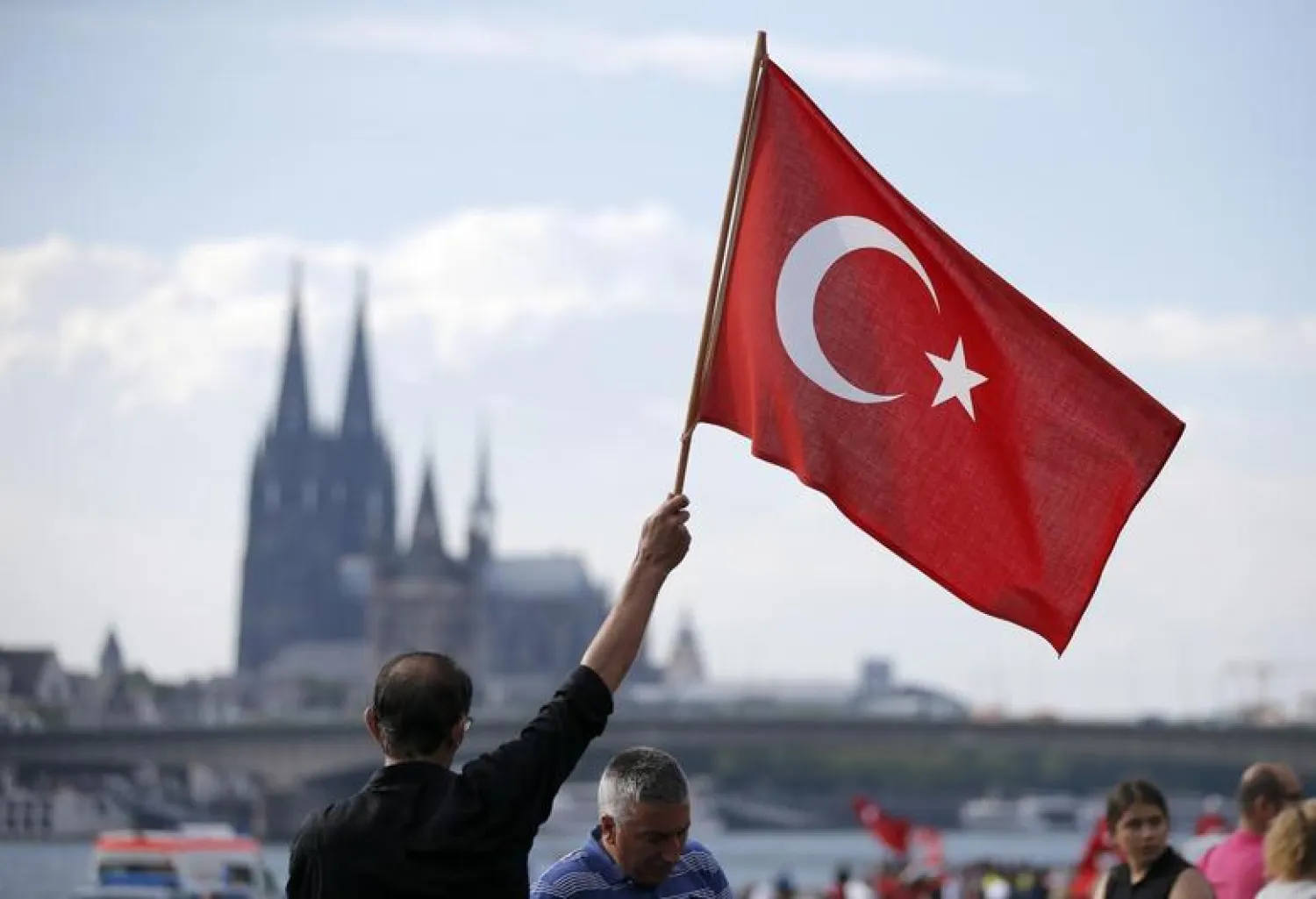 A supporter of Turkish President Tayyip Erdogan waves a Turkish flag during a pro-government protest in Cologne, Germany July 31, 2016. REUTERS/Vincent Kessler

