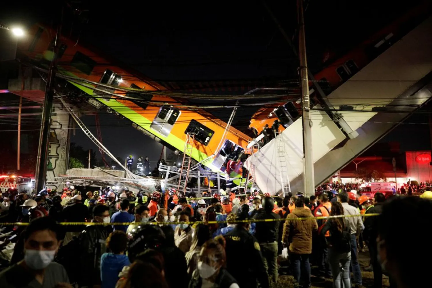 Rescuers work at a site where an overpass for a metro partially collapsed with train cars on it at Olivos station in Mexico City, Mexico May 3, 2021. (Reuters)