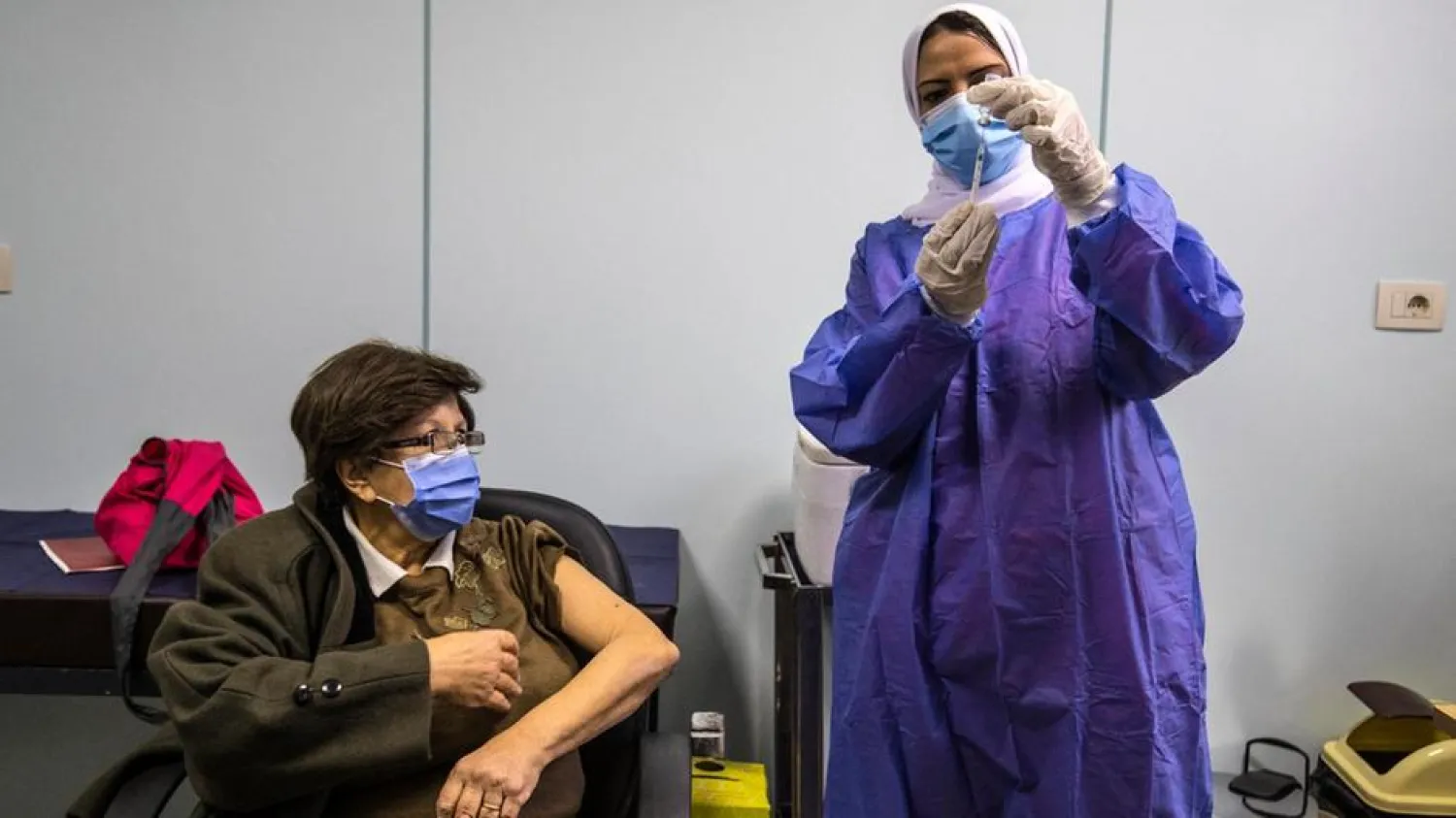  An Egyptian medical worker administers a dose of the Oxford-AstraZeneca Covid-19 vaccine in Cairo. AFP

