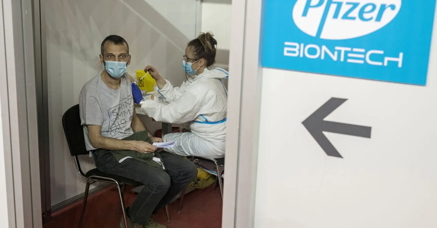 A man receives a second dose of the Pfizer-BioNTech vaccine against the coronavirus disease (COVID-19) at hall three of the Belgrade Fair, in Belgrade, Serbia, April 13, 2021. REUTERS/Marko Djurica