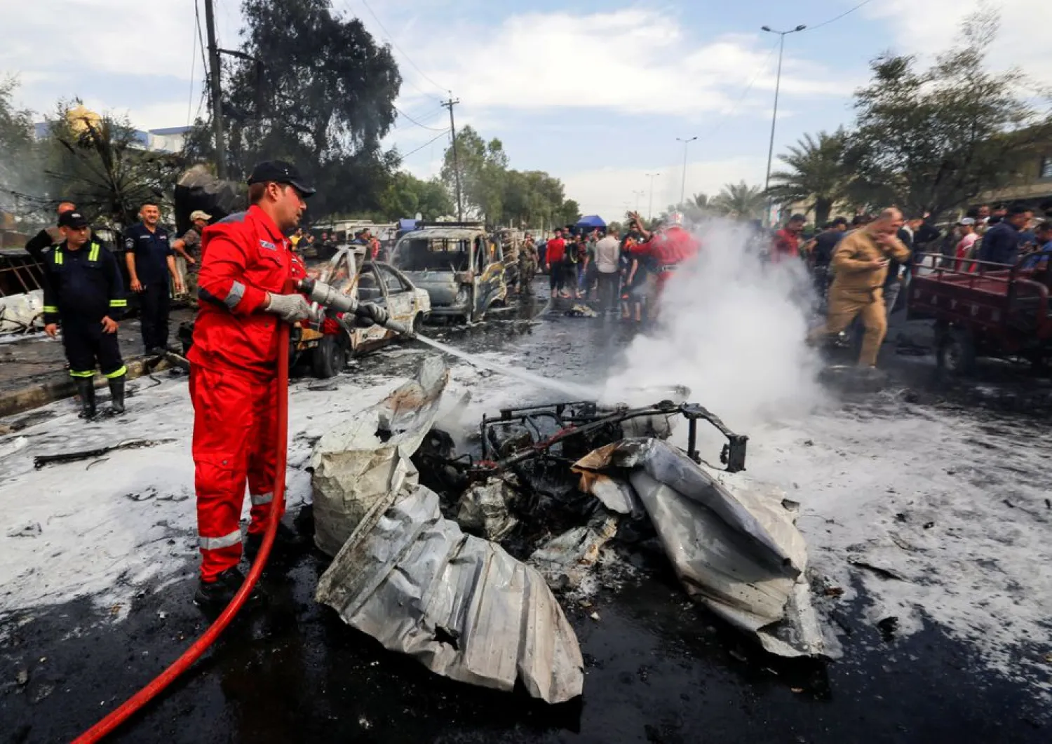 A firefighter inspects the site of a car bomb attack in Sadr City district of Baghdad, Iraq April 15, 2021. (Reuters)