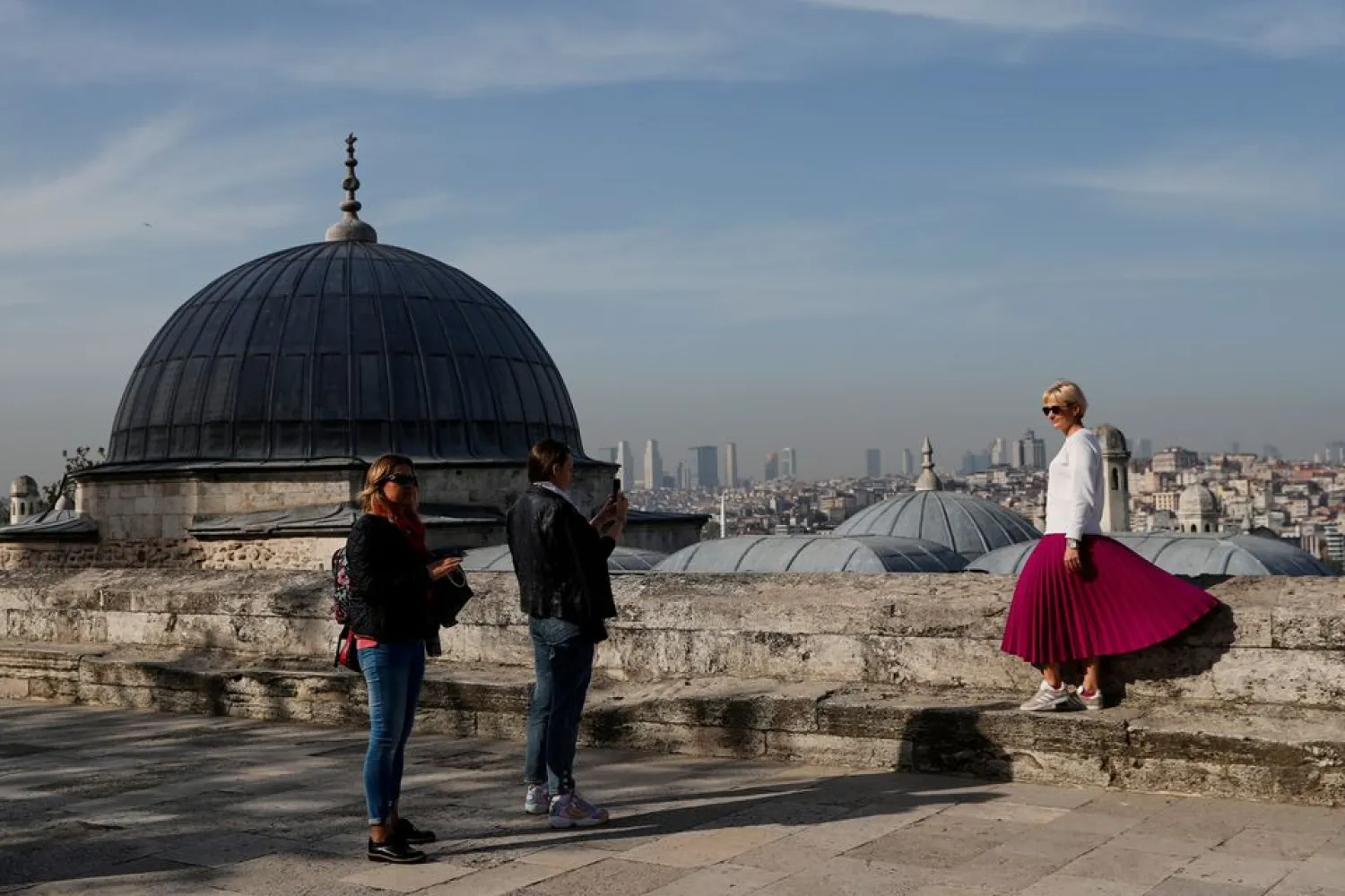 Tourists outside the Suleymaniye Mosque in Istanbul, Turkey, during a nationwide lockdown of the local population imposed to slow the spread of COVID-19, April 30, 2021. (Reuters)