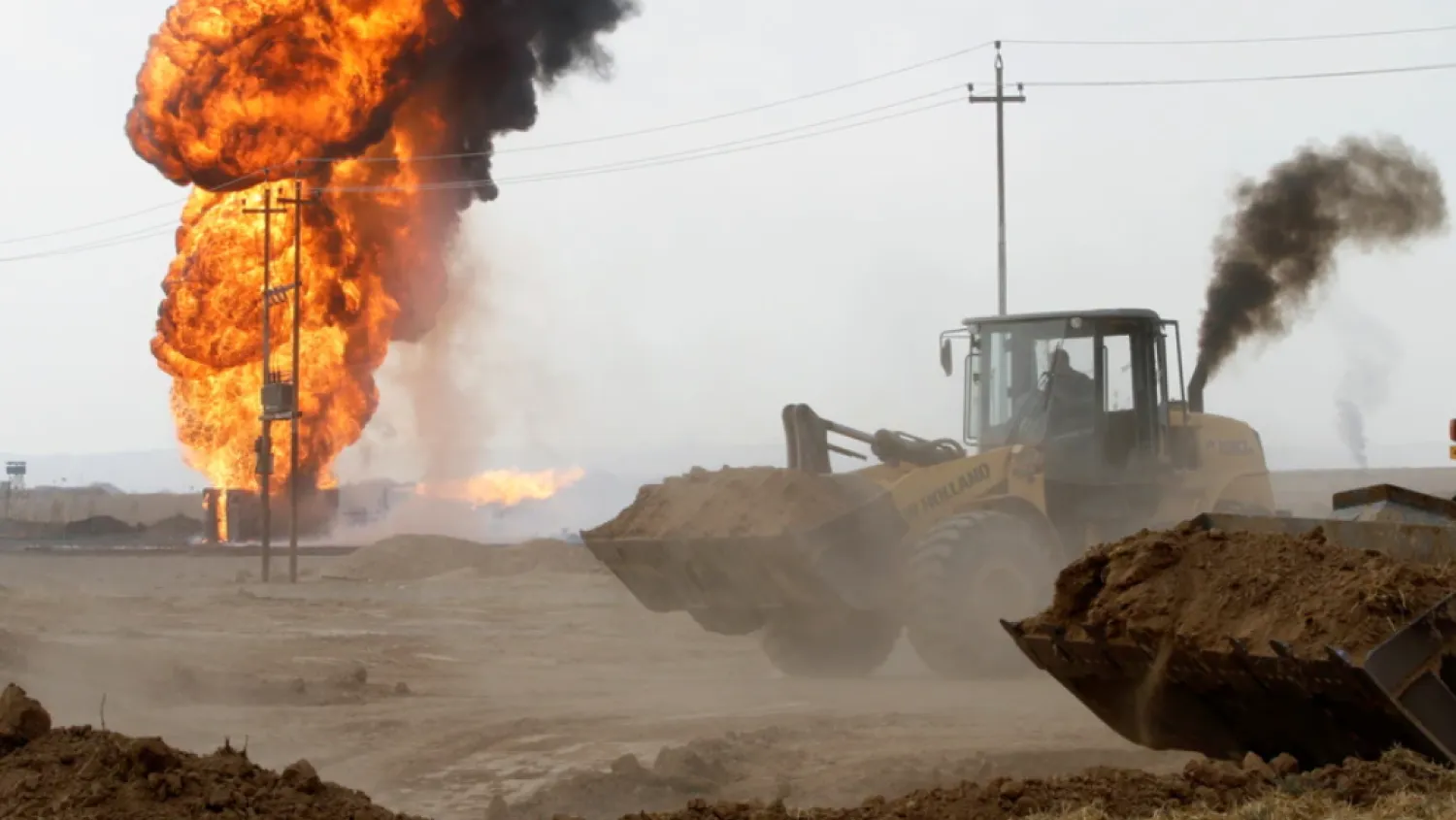 Flames and smoke rise from oil wells inside the Khabbaz oilfield after they were bombed on the outskirts of Kirkuk, Dec 9, 2020. Reuters
