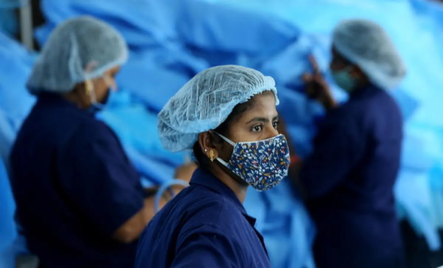  Indian laborers work at the Personal protective equipment (PPE) Kit production factory in Bangalore, India, 06 May 2021. EPA