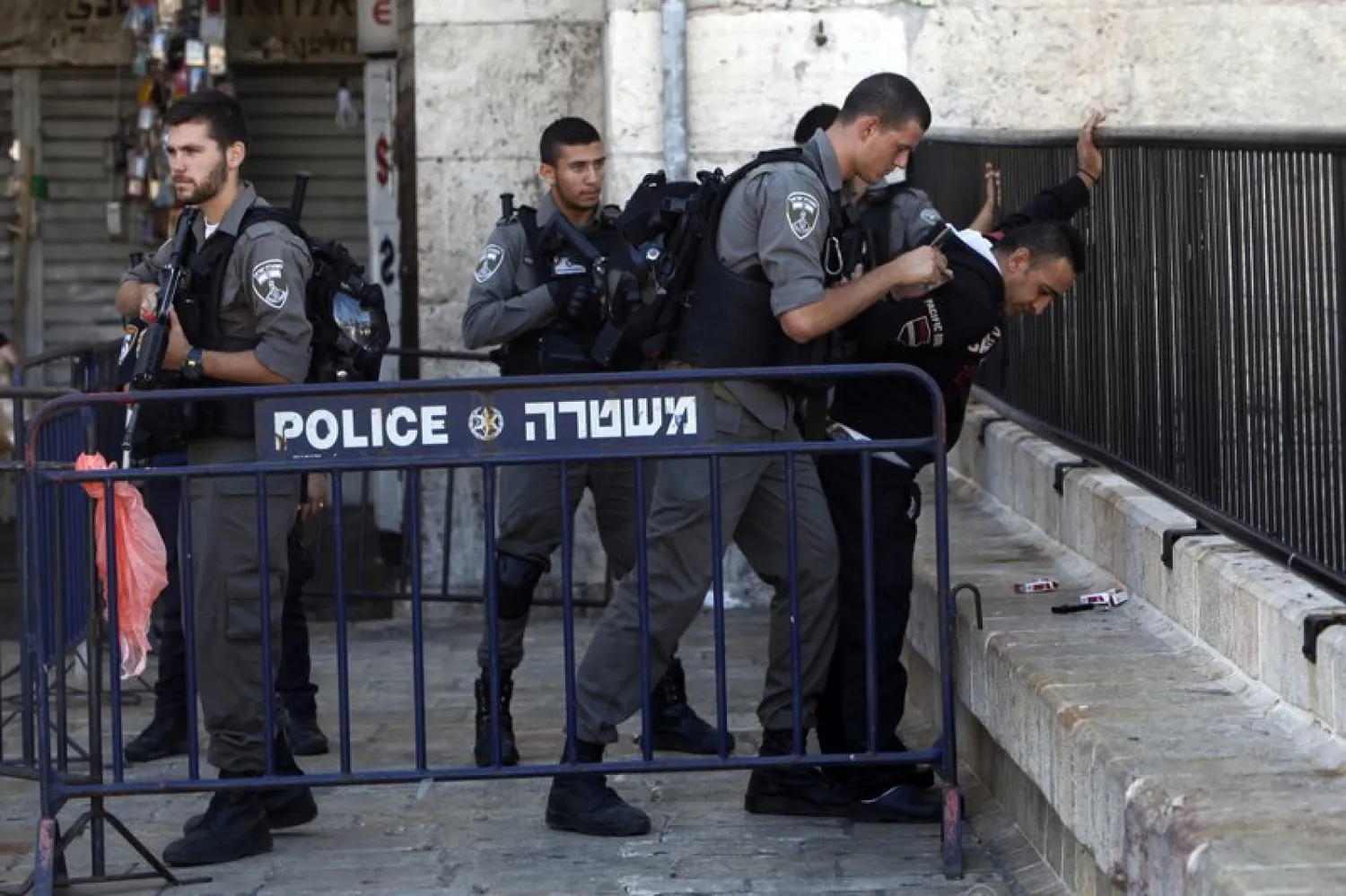 Israeli border police officers search a Palestinian man near the scene of a stabbing attack in Jerusalem's old city, Monday, Sept. 19, 2016. (AP Photo/Mahmoud Illean)

