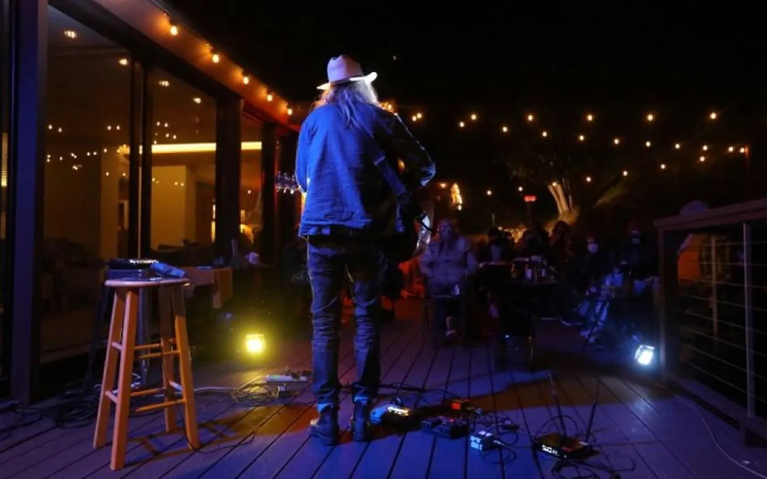 Singer-songwriter Steve Poltz plays a private concert in front of a small crowd on a resident's back porch, in Piedmont, California, US, April 30, 2021. (Reuters)