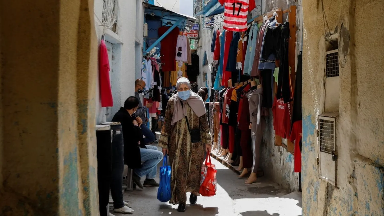 A woman wearing a protective face mask walks in the Medina, in the old city of Tunis, amid the coronavirus disease (COVID-19) outbreak, Tunisia, April 29, 2021. (Reuters)