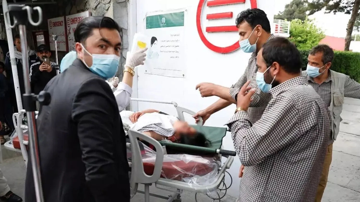 An injured woman is transferred to hospital after a bomb went off near a school in Kabul on May 8, 2021. (Reuters)