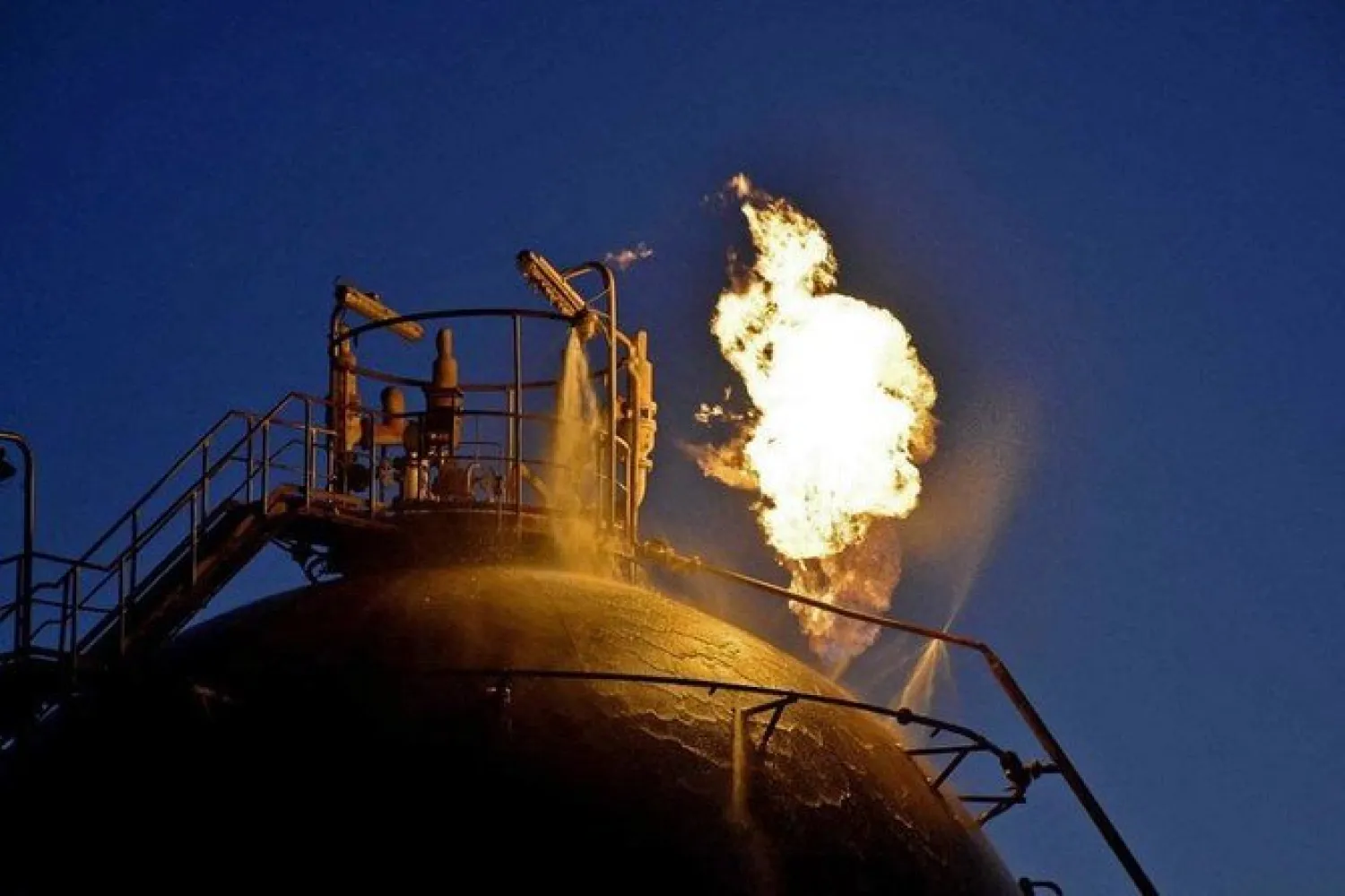 Flame erupts from an oil tank following an attack on Syria's Homs Refinery. (File/AFP)
