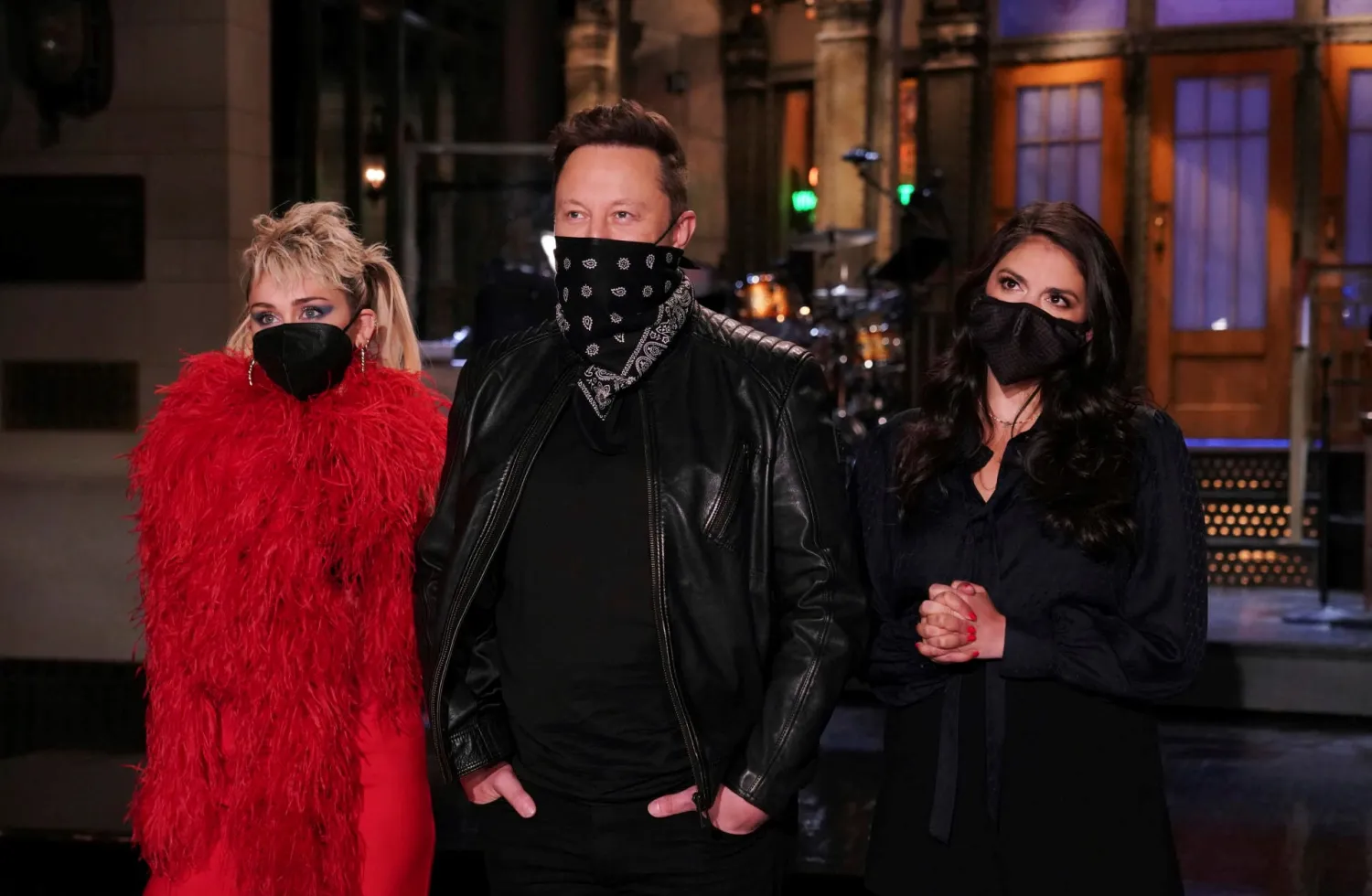 This image released by NBC shows musical guest Miley Cyrus, from left, host Elon Musk, and Cecily Strong during promos in Studio 8H on Thursday, May 6, 2021. (Rosalind O'Connor/NBC via AP)