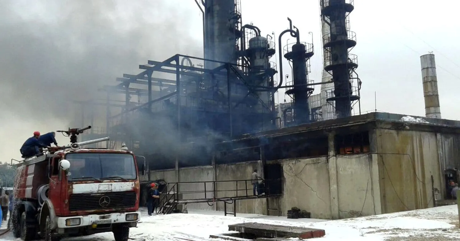Firefighters try to put out a fire in main Homs refinery, Syria, in this handout picture released on May 9, 2021. SANA/Handout via REUTERS