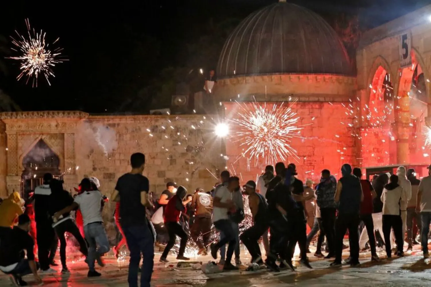 Stun grenades burst in the air amid clashes between Palestinian protesters and Israeli security forces at the al-Aqsa mosque compound in Jerusalem, on May 7, 2021 | PHOTO: AFP
