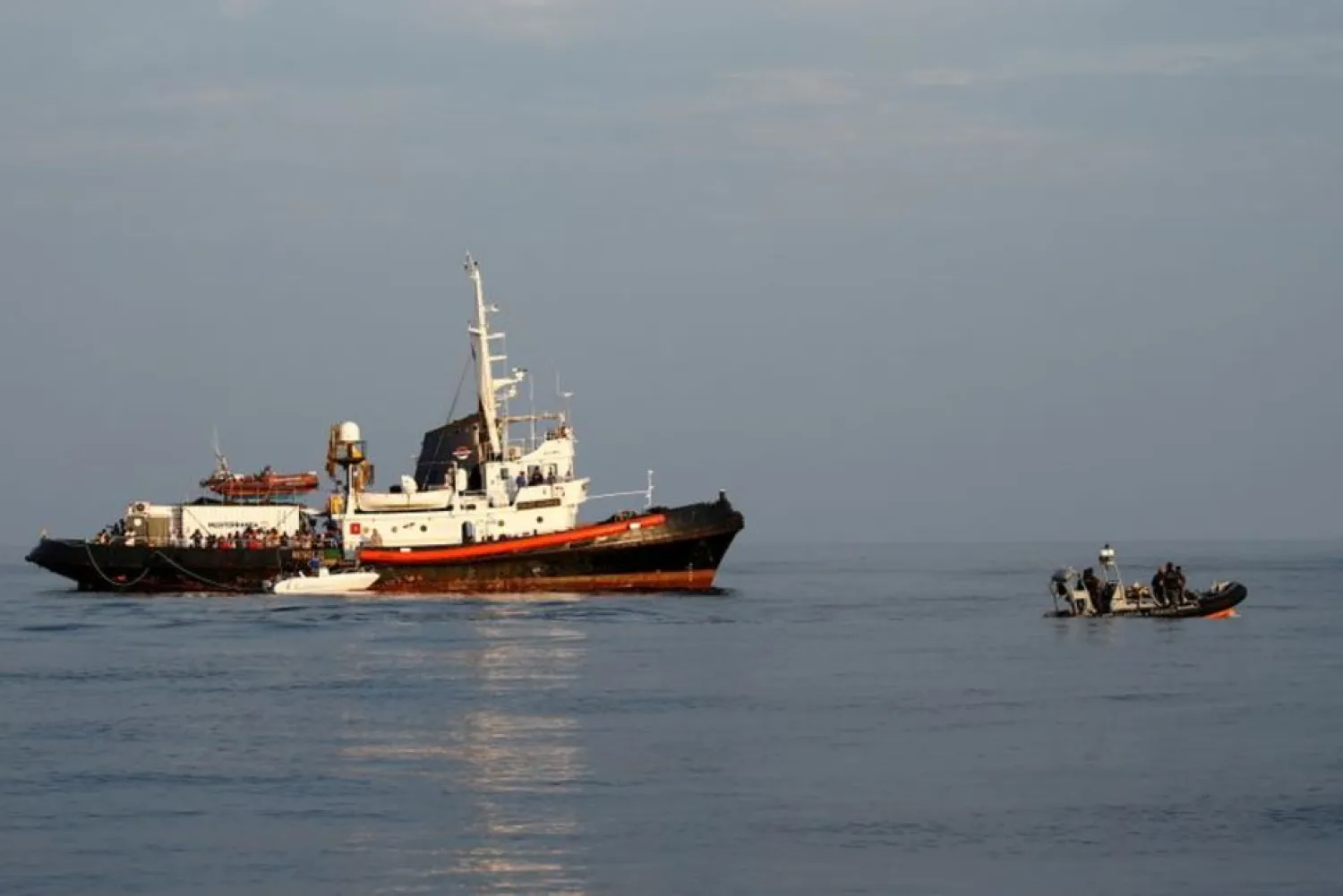 FILE PHOTO: A rigid-hulled inflatable boat (RHIB) of the Italian Finance Police patrols near the Mare Jonio, operated by Italian charity Mediterranea Saving Humans, and the German NGO Sea-Eye migrant rescue ship 'Alan Kurdi' (unseen) in international waters of the Italian island of Lampedusa in the central Mediterranean Sea, August 31, 2019. REUTERS/Darrin Zammit Lupi/File PhotoREUTERS

