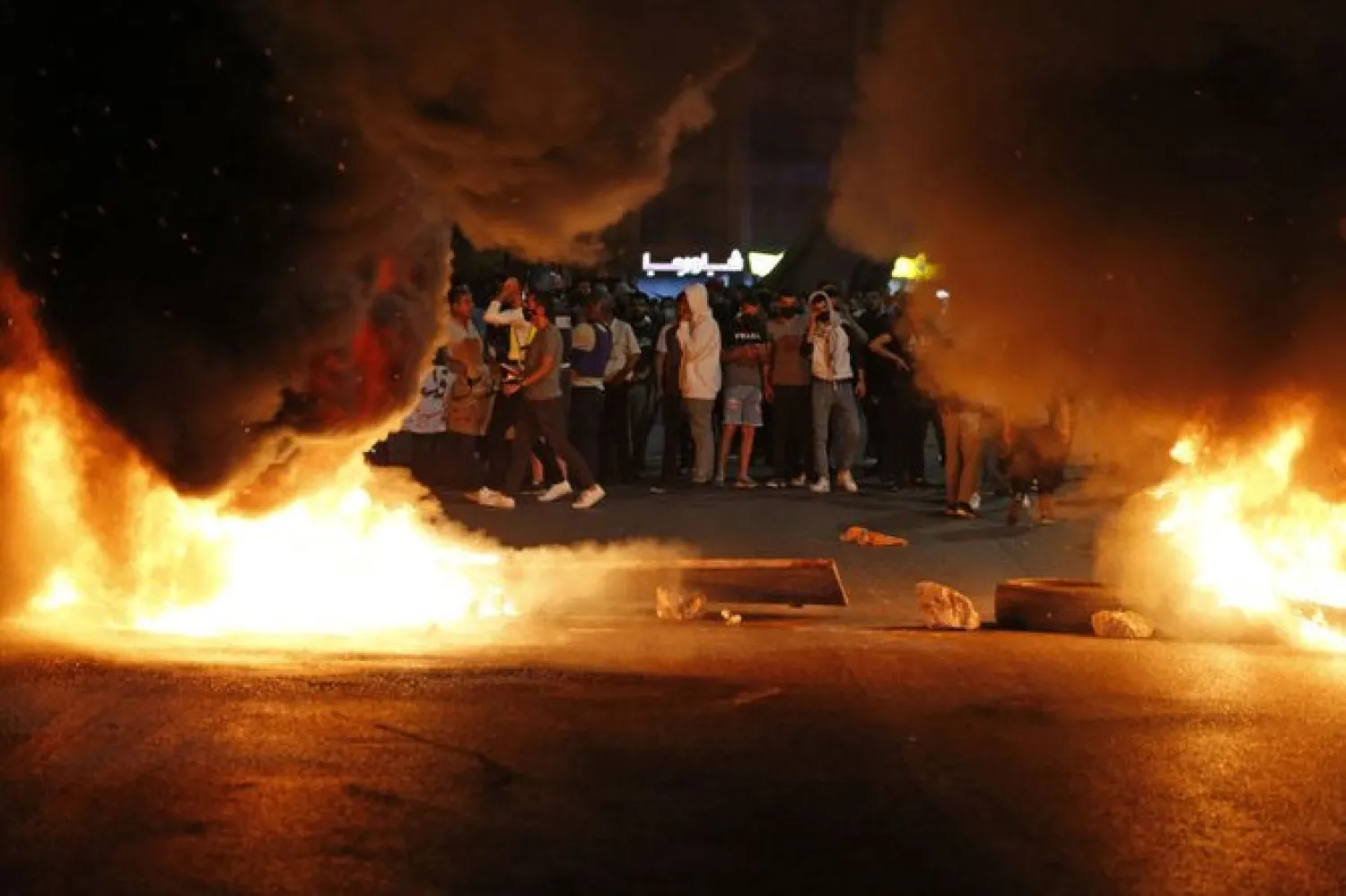 Palestinian protesters burn tires during an anti-Israel demonstration over tension in Jerusalem, near the Jewish settlement of Beit El near Ramallah, in the occupied West Bank, on May 10, 2021. ( AFP / ABBAS MOMANI)
