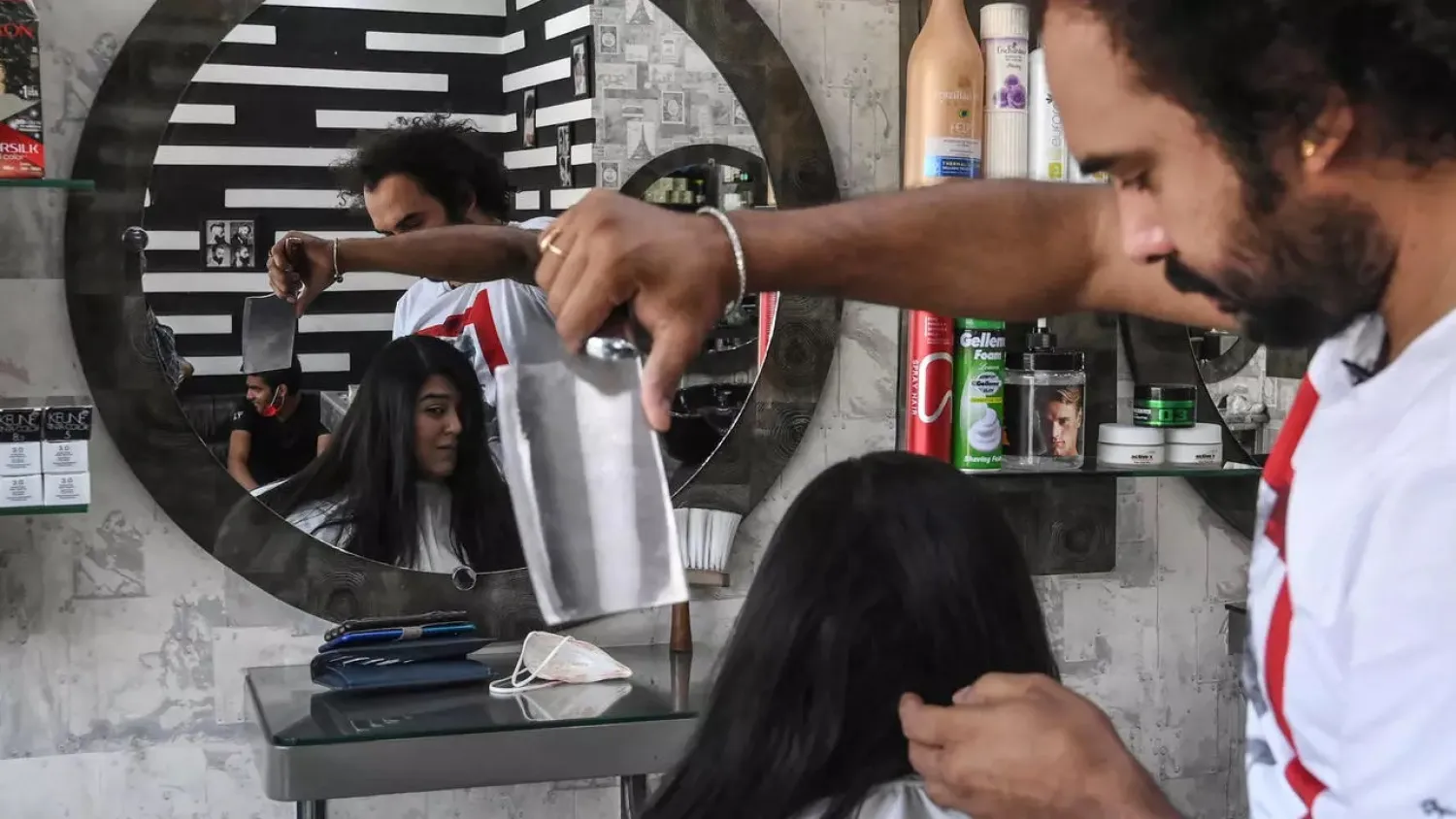 Abbas's fringe style is proving a hit in the conservative nation, with customers flocking to his shop in the eastern city of Lahore. (AFP)